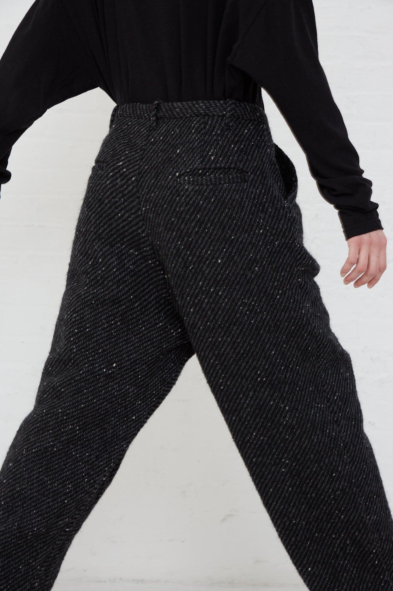 A woman wearing the Snow Nep Wool Pant in Black by Ichi Antiquités. Up close and back view.