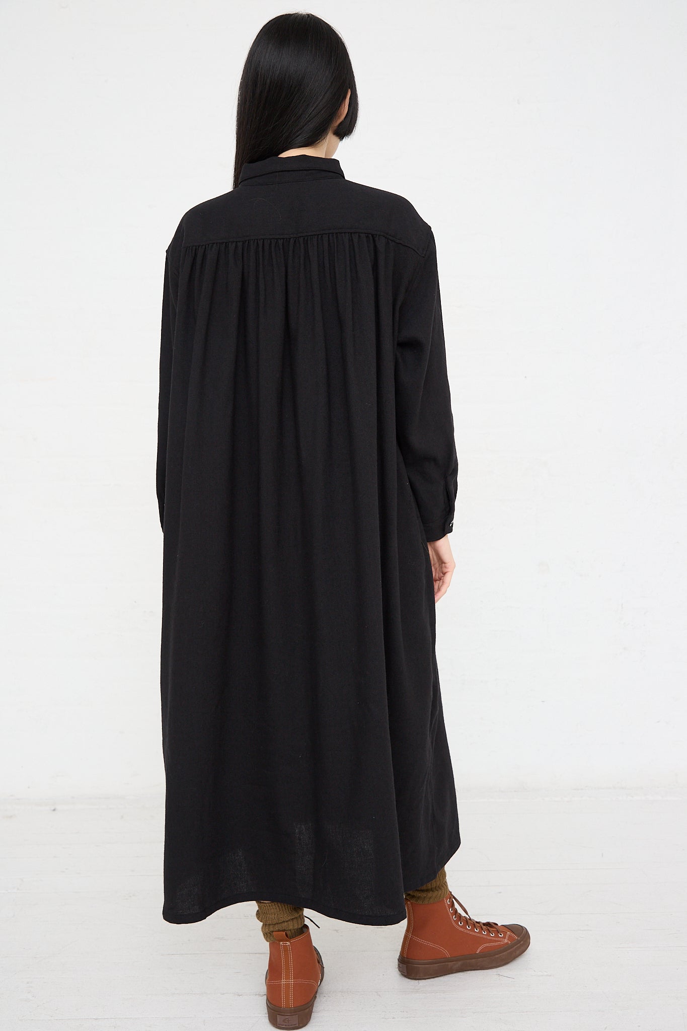 The back view of a woman wearing an Ichi Woven Dress in Black.