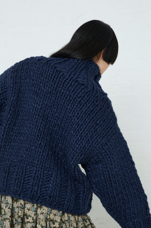 An oversized turtleneck pullover in an Ichi Wool Hand-Knit Pullover in Navy. Back view.