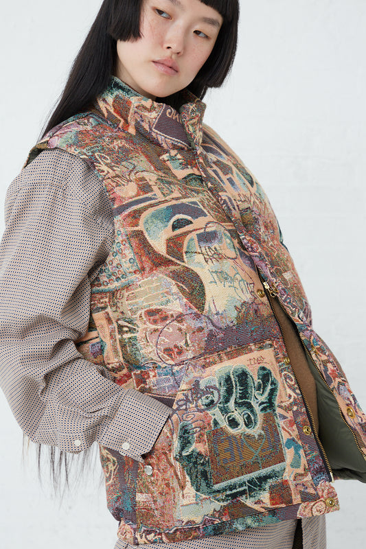 A woman wearing the Bless Down Vest No. 75 in Goelin Graffiti, made of printed cotton blend fabric with snap closure.