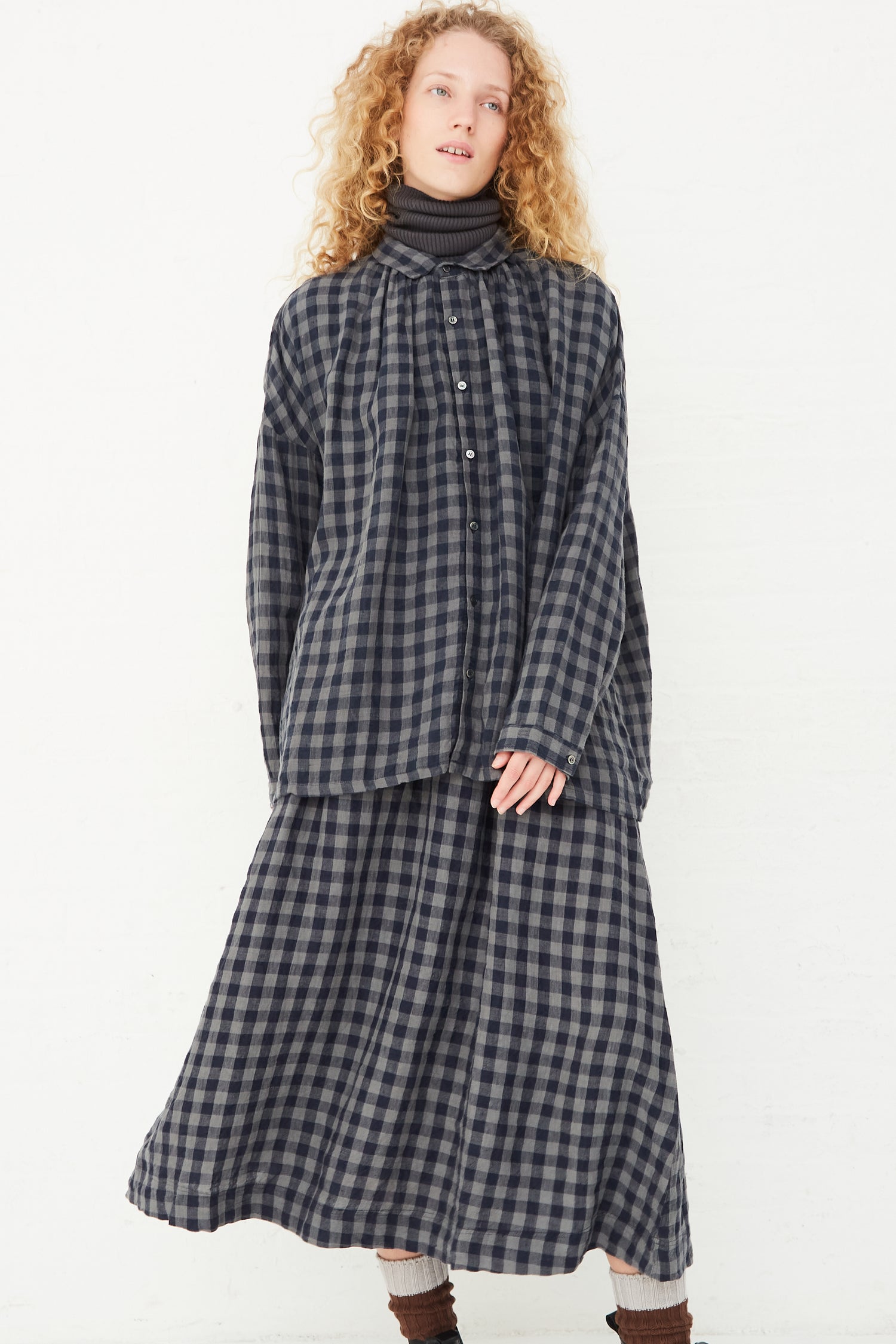 A model wearing an Ichi Antiquités Azumadaki Linen Gingham Shirt in Charcoal, available at Oroboro store.