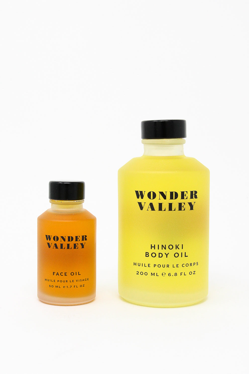 A bottle of Wonder Valley Face Oil, known to hydrate and revive various skin types, combined with a bottle of nourishing jojoba oil.