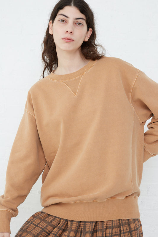 A model wearing an Ichi Antiquités Pigment French Terry Cotton Pullover in Camel.