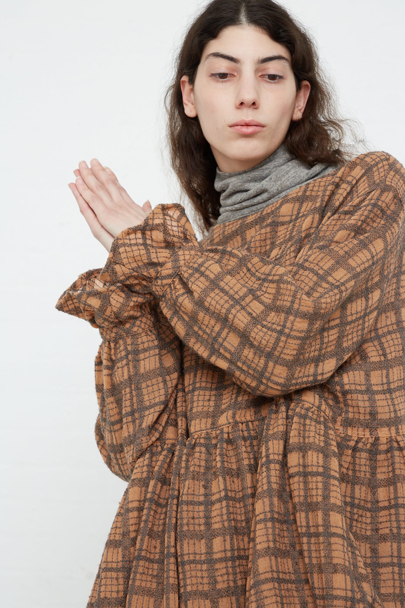 The model is wearing the Ichi Antiquités Woven Wool Check Dress in Terracotta.