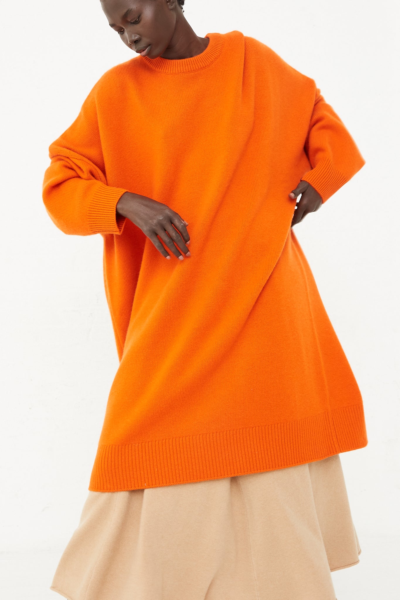 An Extreme Cashmere No. 303 Sandra Dress in Maple sweater dress.