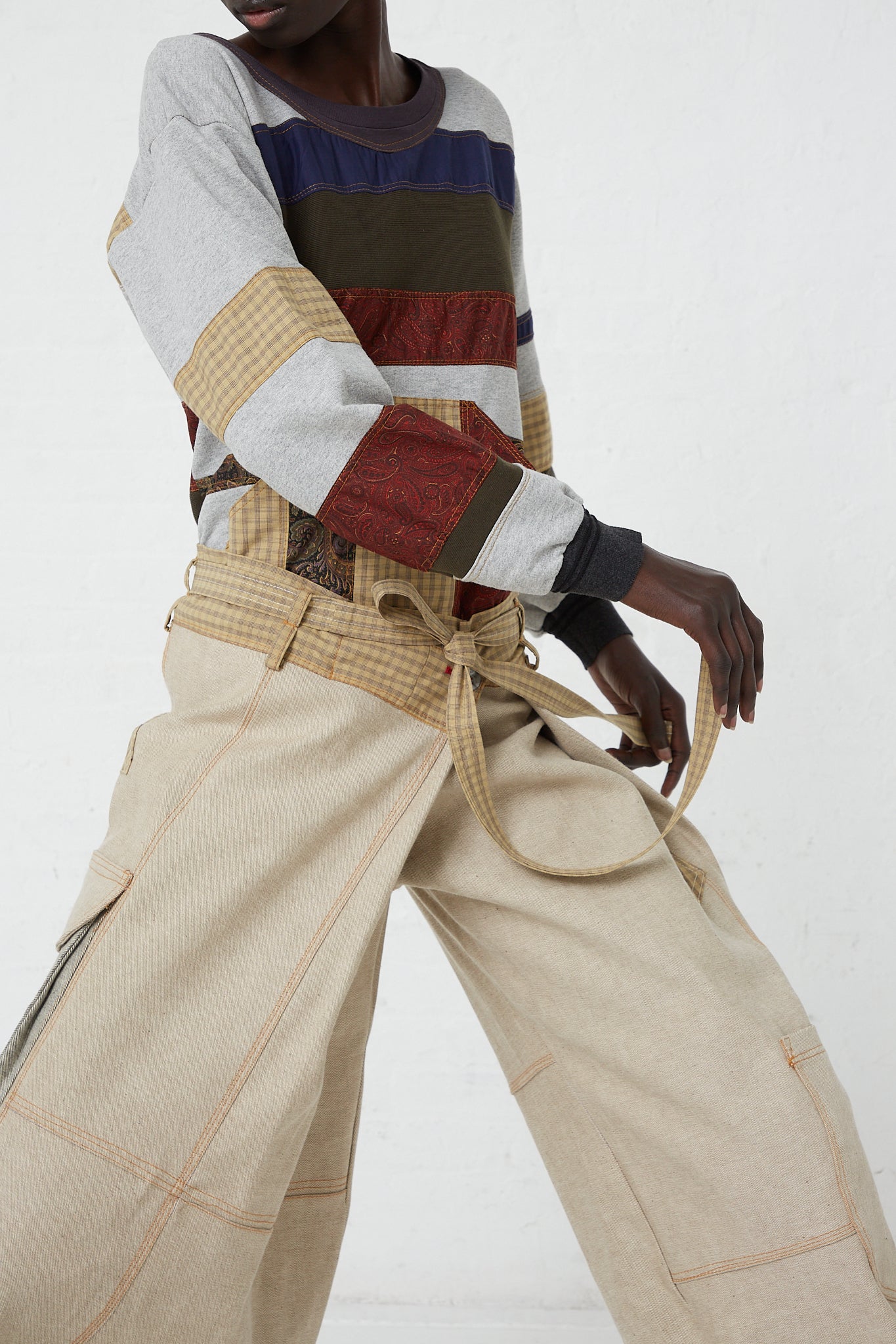 A woman wearing a striped sweater and wide leg Check Cotton Jupiter Pant in Tent pants by brand SC103.