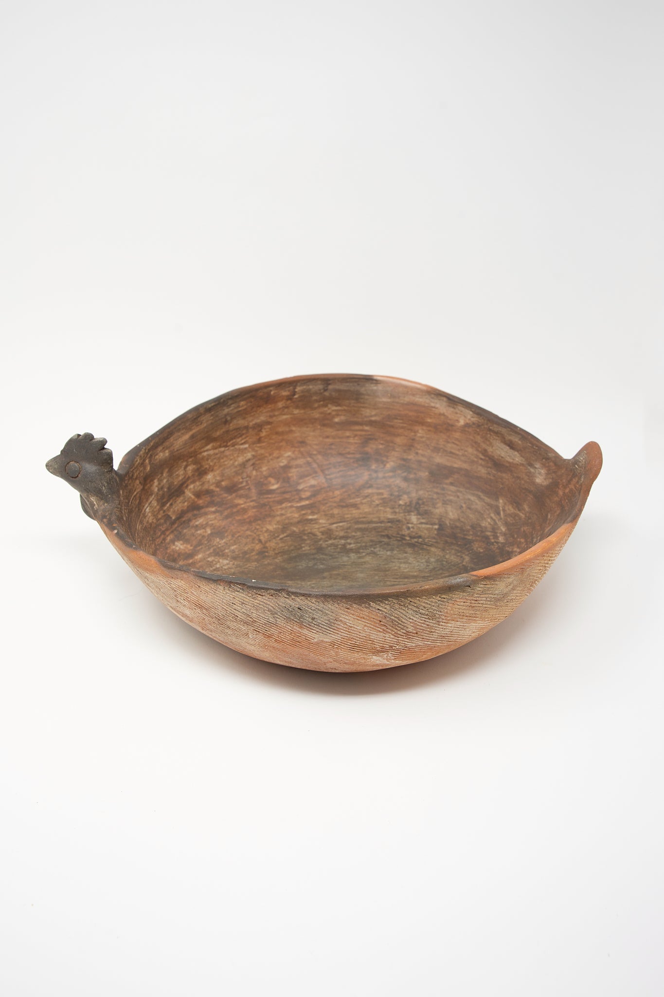 A Julia Bowl of Illusions in Red Clay with a bird on it.