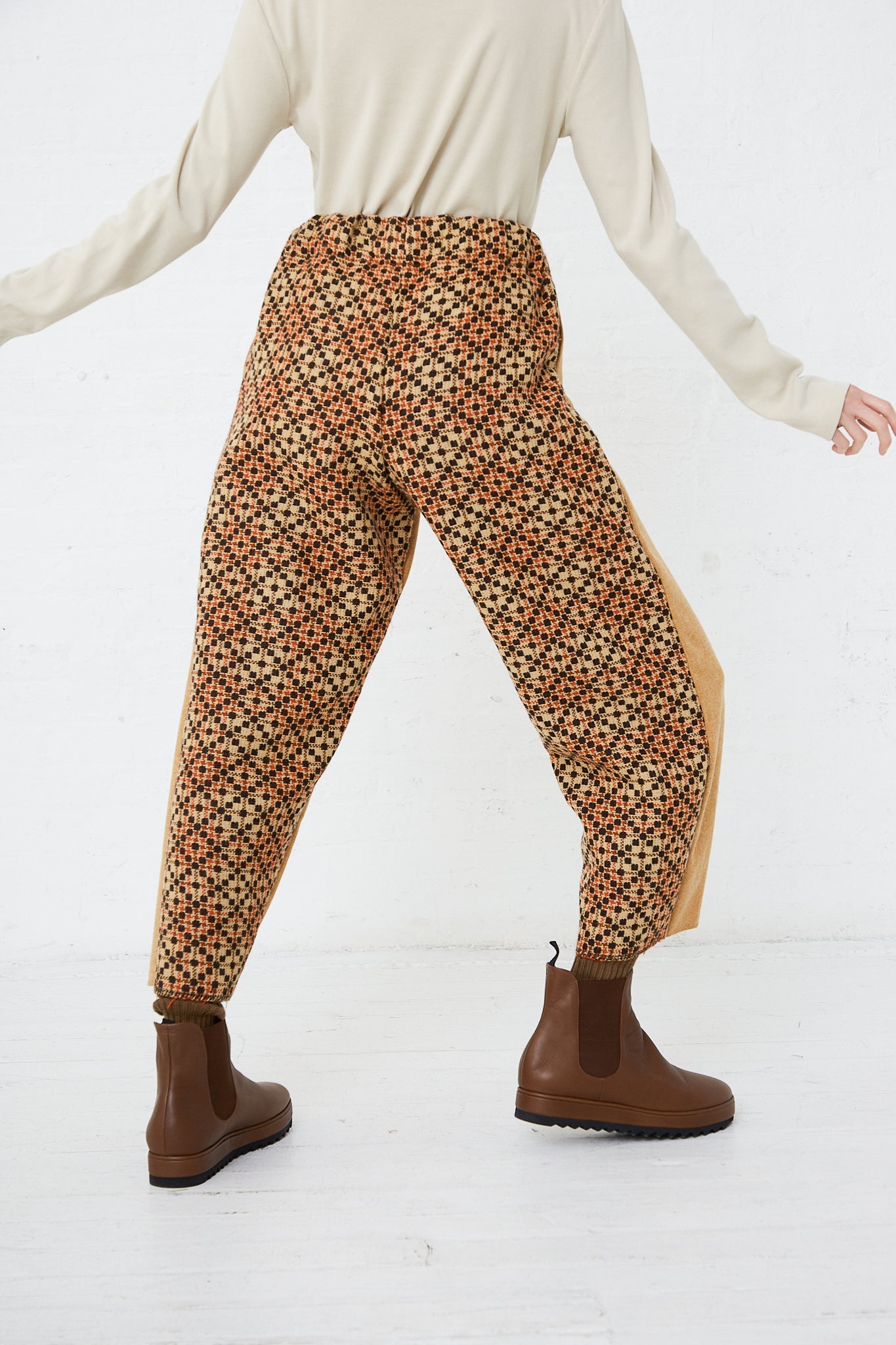 A woman wearing Thank You Have A Good Day's Wool Contrast Project Suit in Mustard harem pants. Back view.