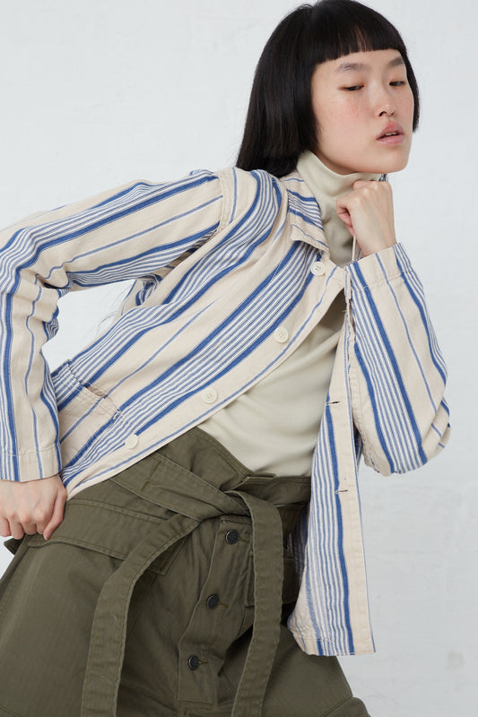 A woman wearing the As Ever Henri Jacket in Vintage Blue Stripe and green pants made of vintage textile cotton.
