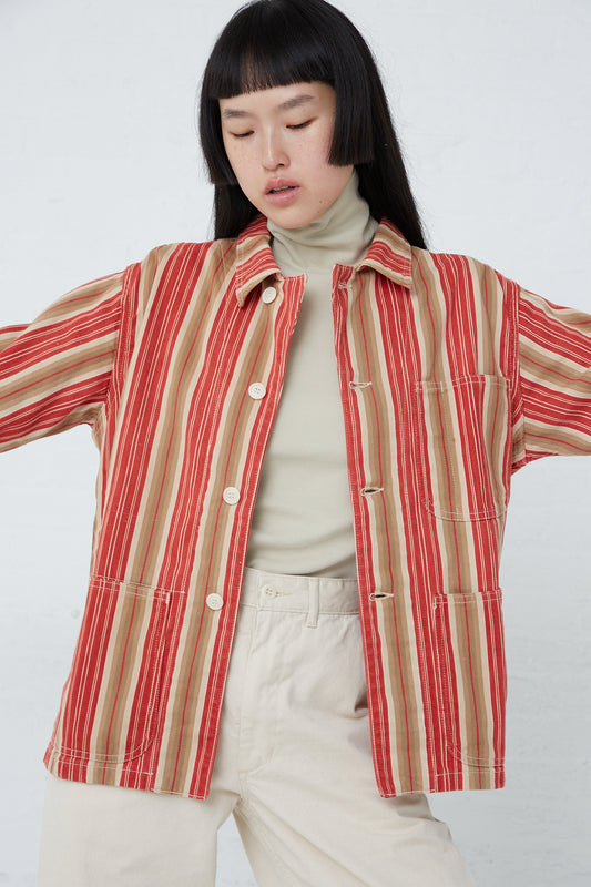 A model wearing the As Ever Henri Jacket in Vintage Red Stripe, a military-inspired red and tan striped jacket made from vintage textile cotton.