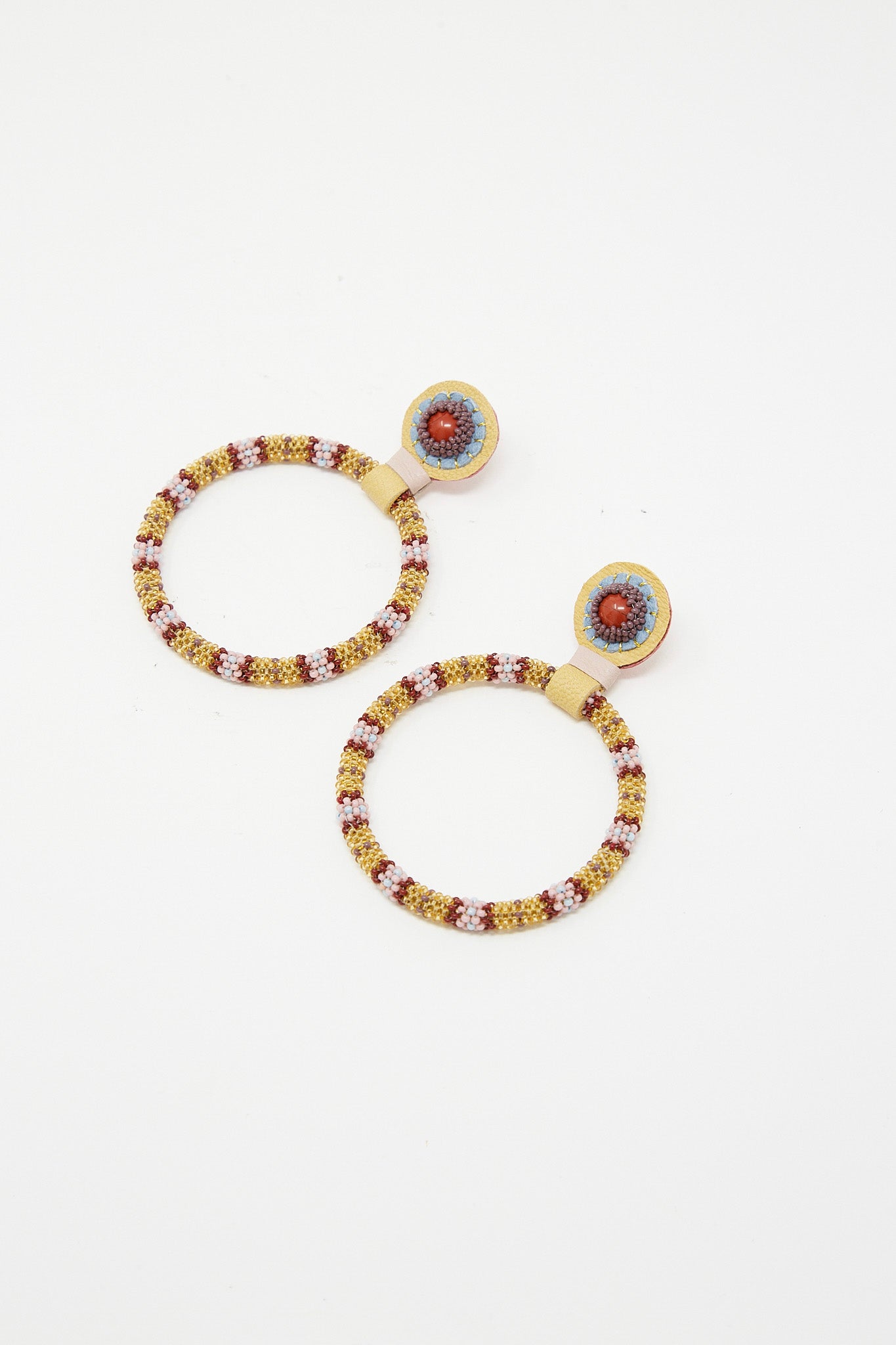 A pair of Large Beaded Hoops in Red Jasper Stones by Robin Mollicone with red and blue beads.