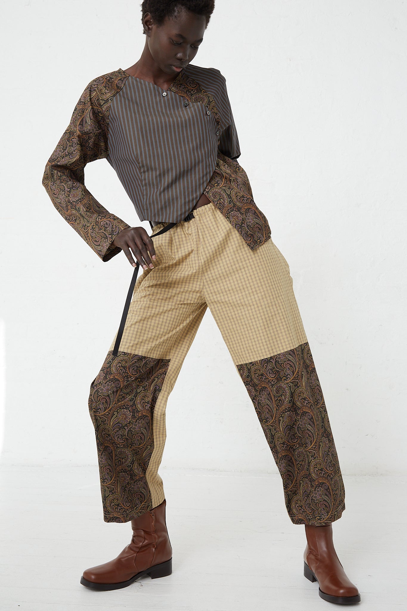 A woman in SC103 Check Cotton Domain Pant in Tent with an adjustable waist belt.
