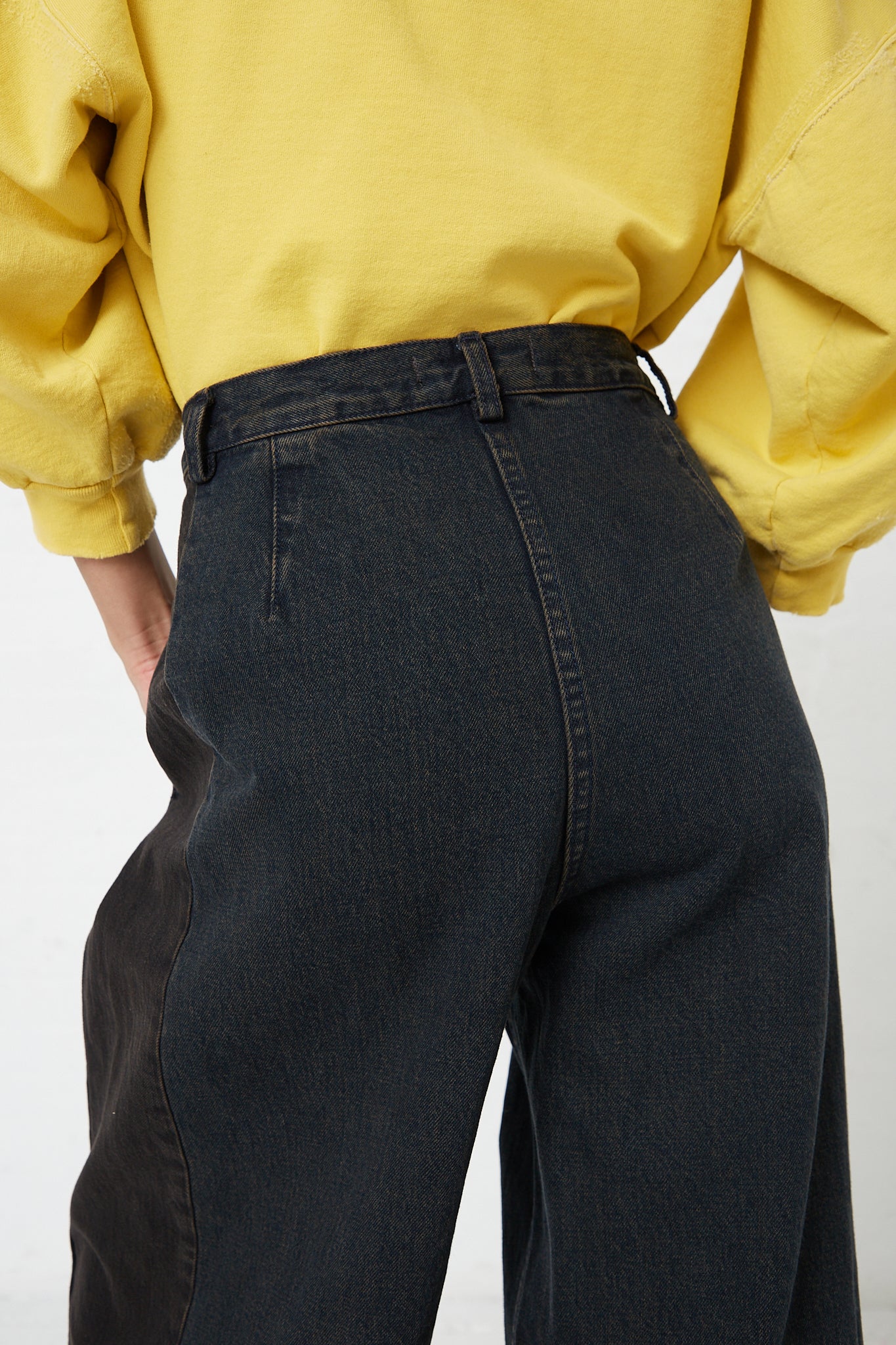 The back view of a woman wearing a Rachel Comey Denim Garra Pant in Brown.