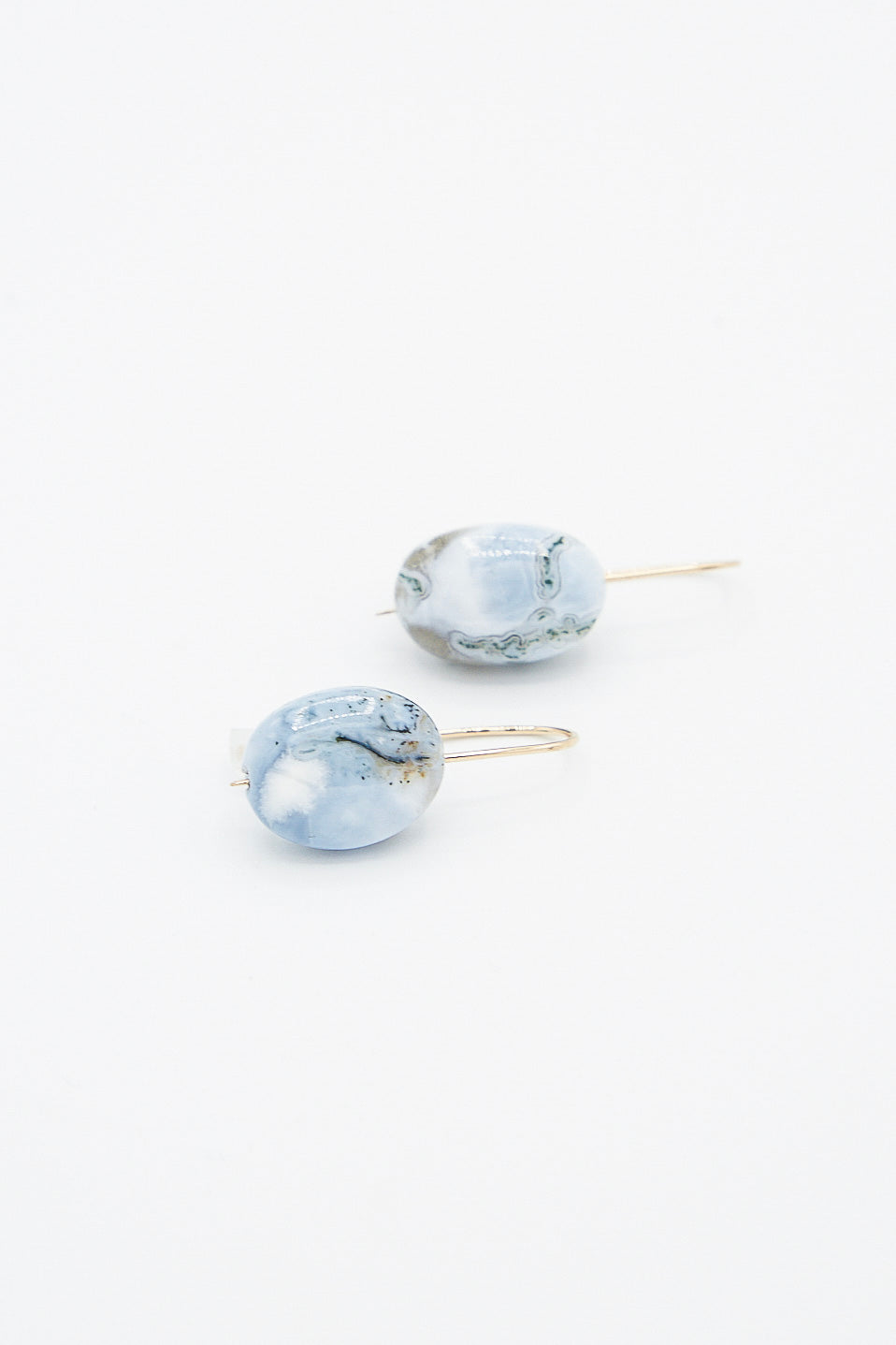 A pair of Mary MacGill Textured Blue Opal drop earrings on a white surface. Available at Oroboro Store.