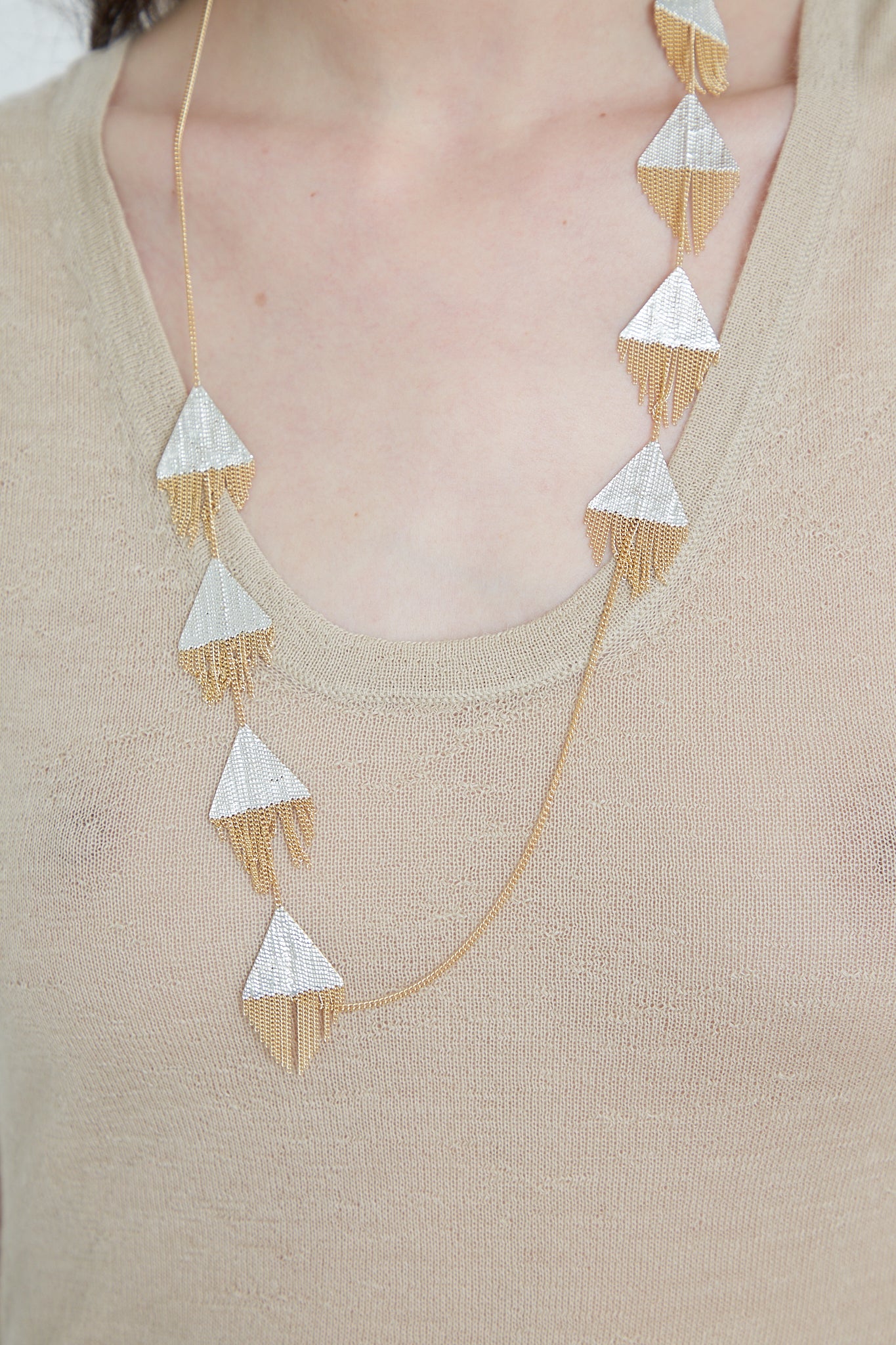 A Hannah Keefe Triangle Necklace in Brass Chain and Silver Solder, crafted using silver soldered brass.