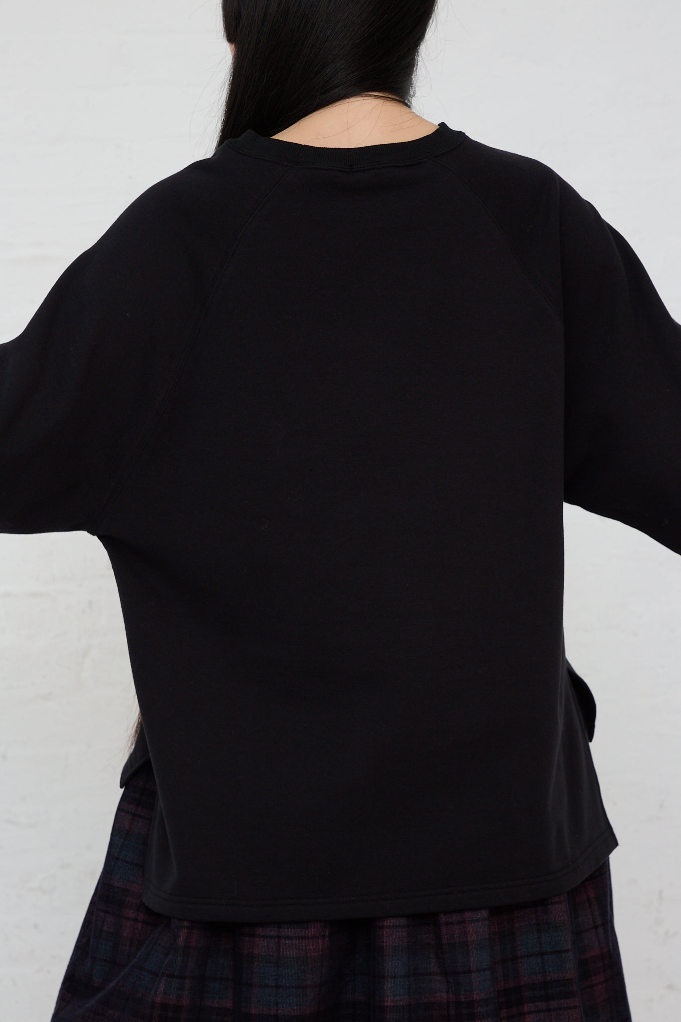 The back of a woman wearing an Ichi Cotton Knit Pullover in Black.