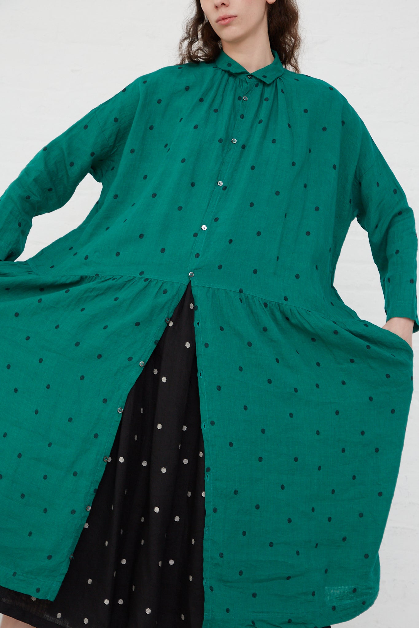 The model is wearing an Ichi Antiquités Linen Dot Dress in Green and Black.