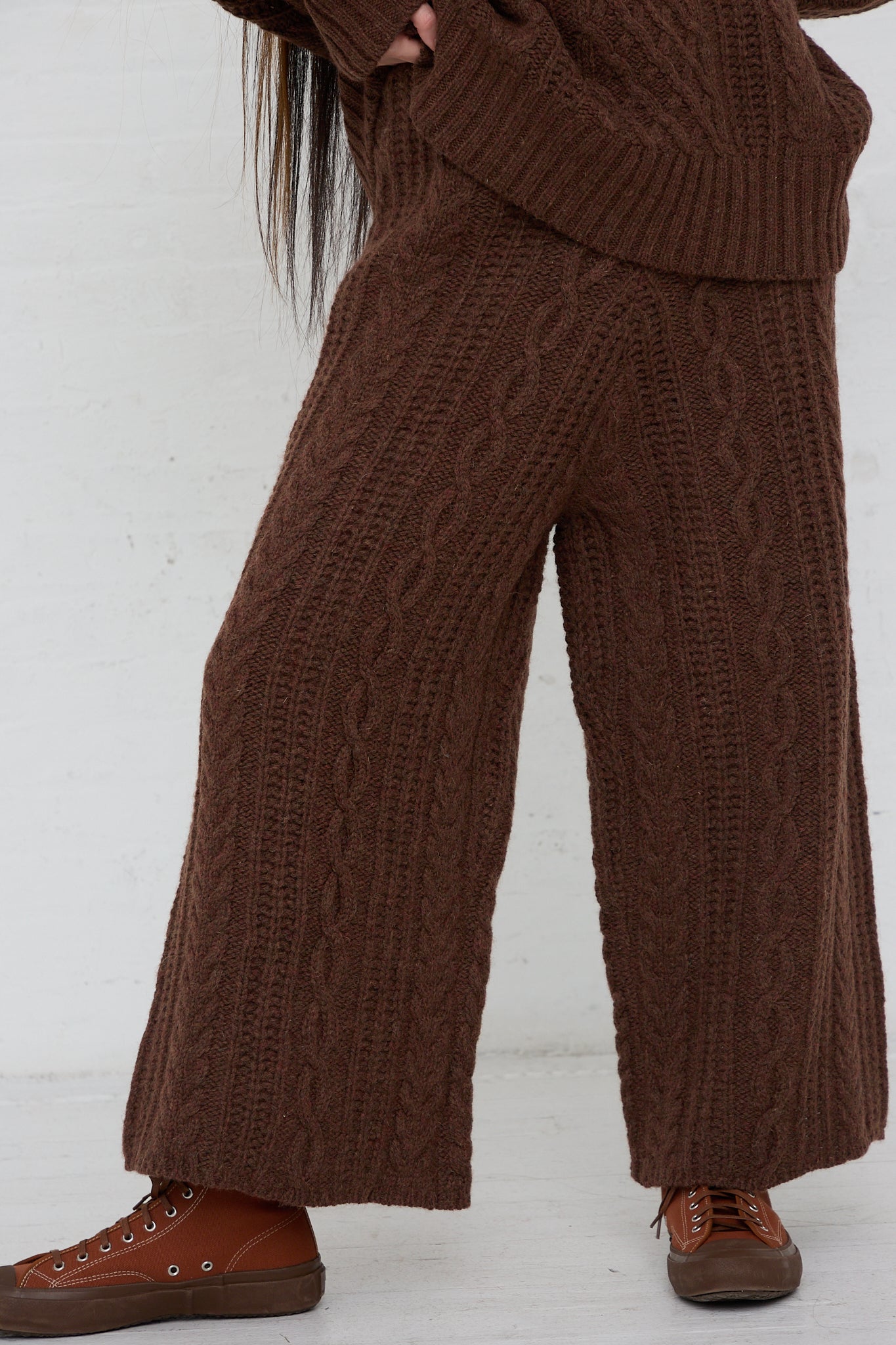 A woman wearing Ichi's Knit Pant in Brown, a wide leg pant. Up close view.