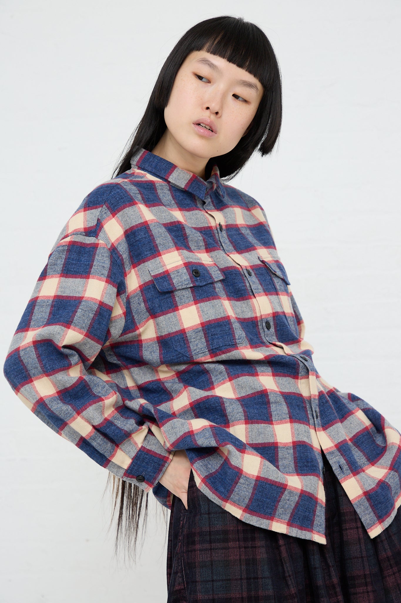 A woman wearing an Ichi woven cotton plaid long sleeve shirt in Ivory and Navy and an Ichi plaid skirt.