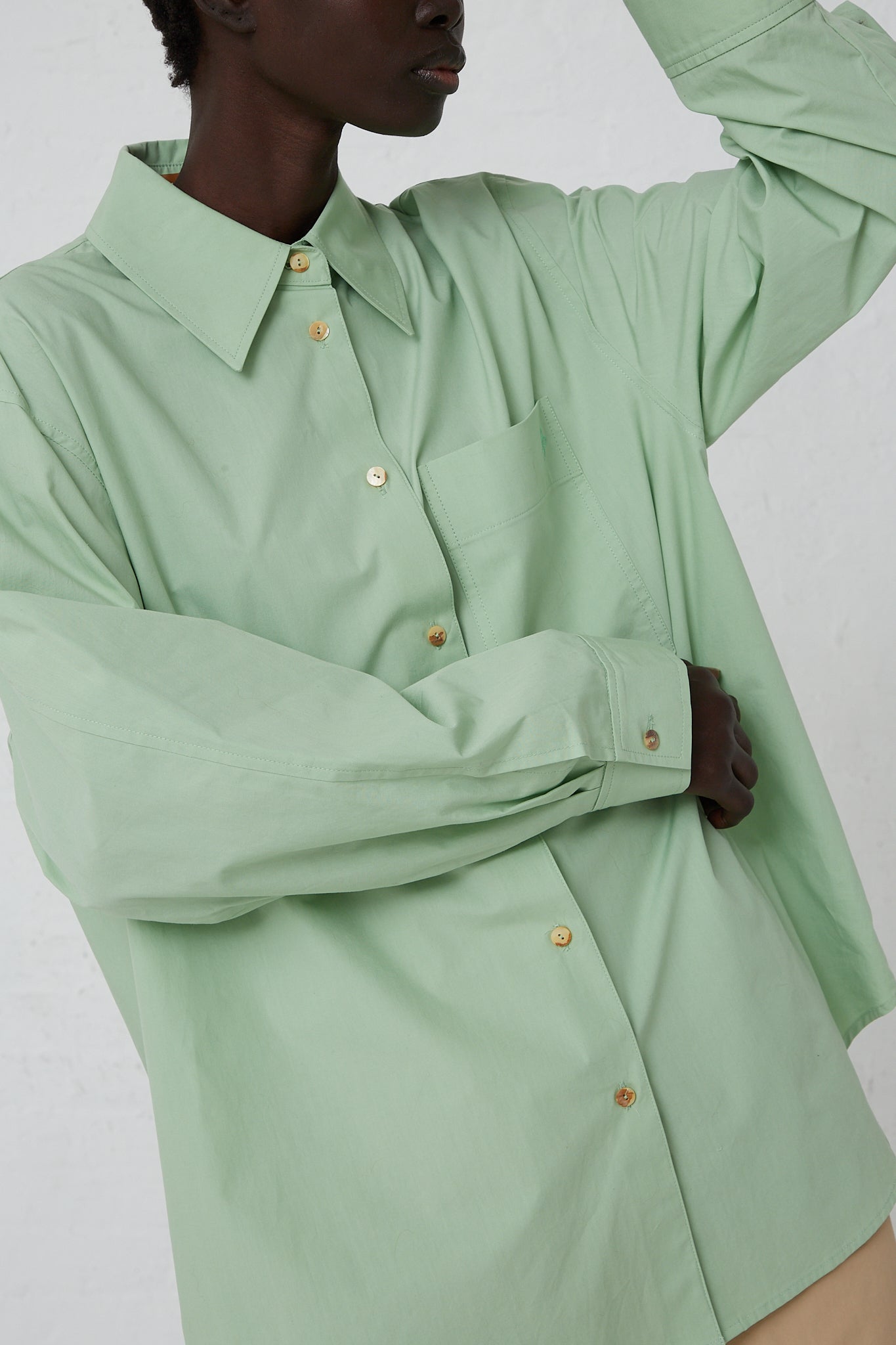 The model is wearing a Rejina Pyo Organic Cotton Caprice Shirt in Mint with a front button closure.