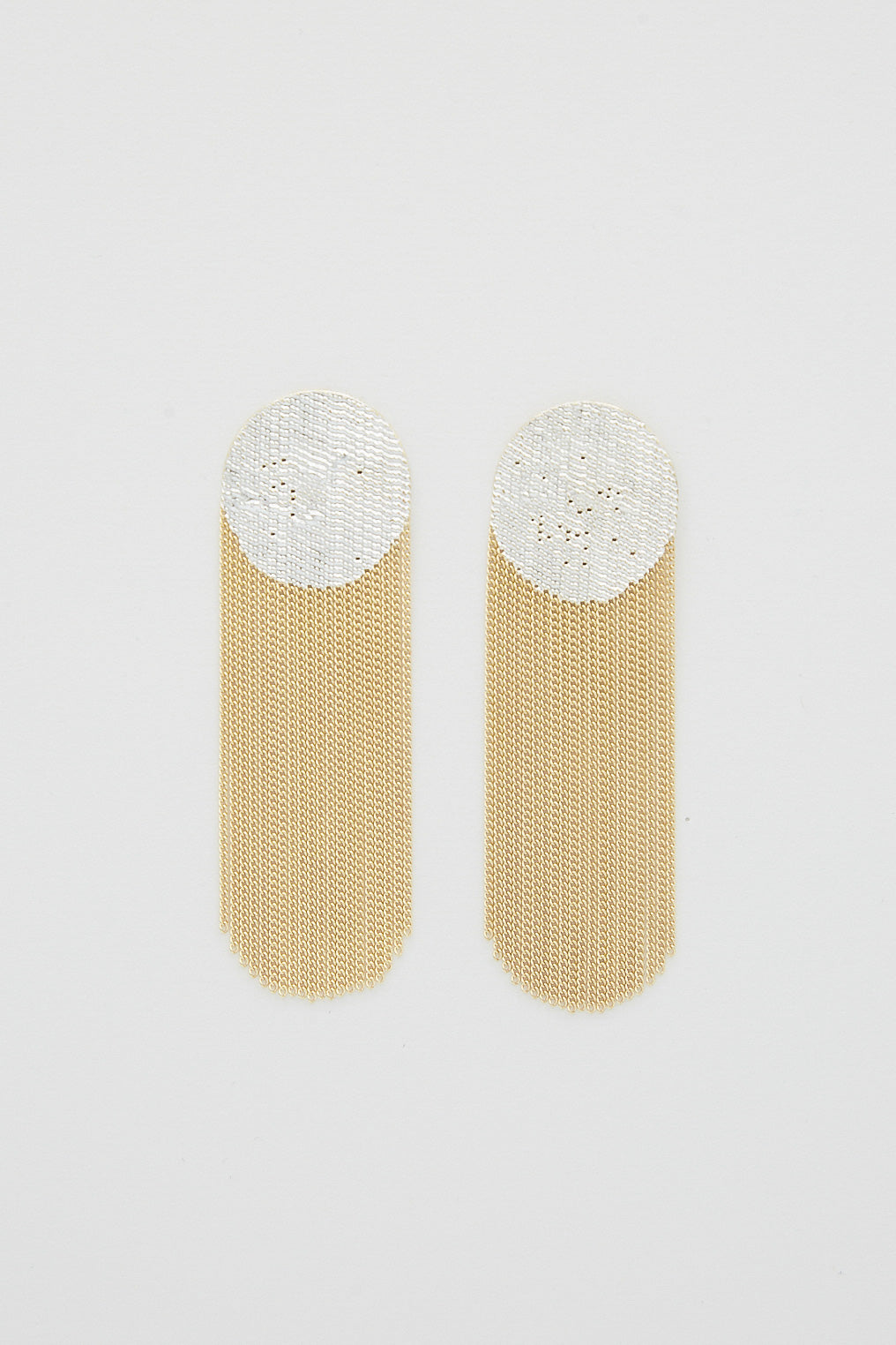 A pair of Dot Earrings in Brass Chain and Silver Solder by Hannah Keefe on a white surface, handmade in California.