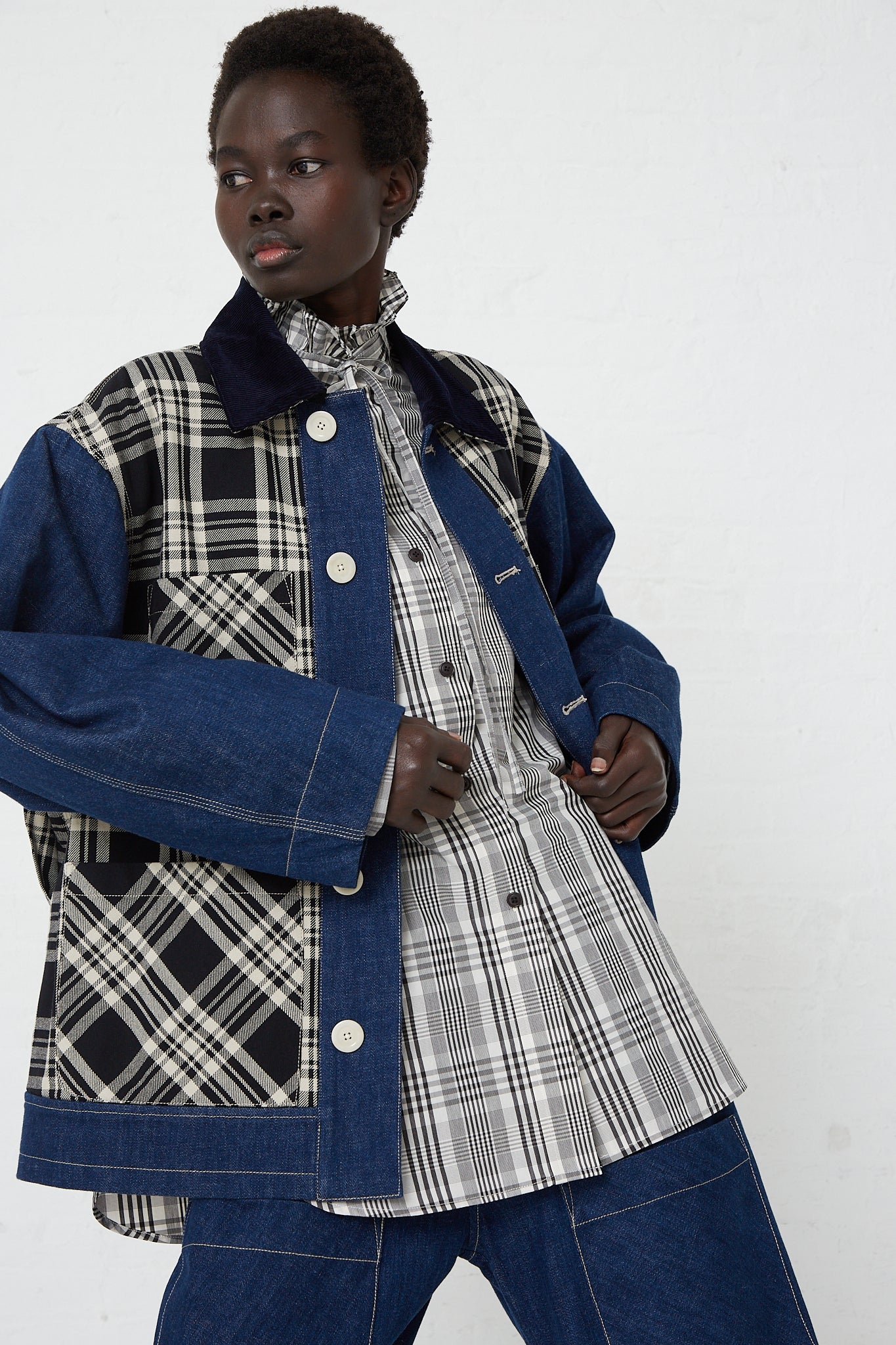 A model wearing a KasMaria Japanese Denim Chore Jacket in Plaid, paired with jeans.