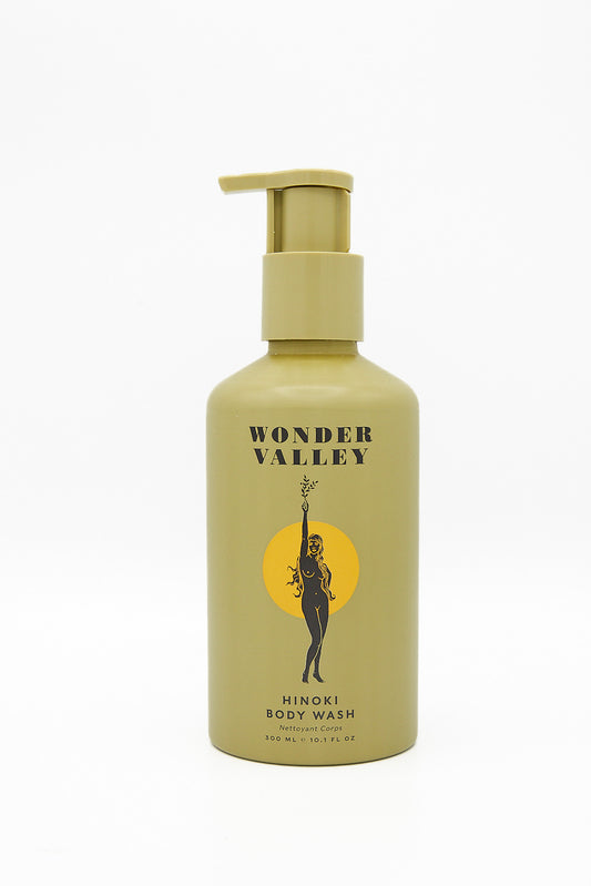 A bottle of Wonder Valley Hinoki Body Wash infused with hydrating hinoki and cedarwood oils, on a white background.