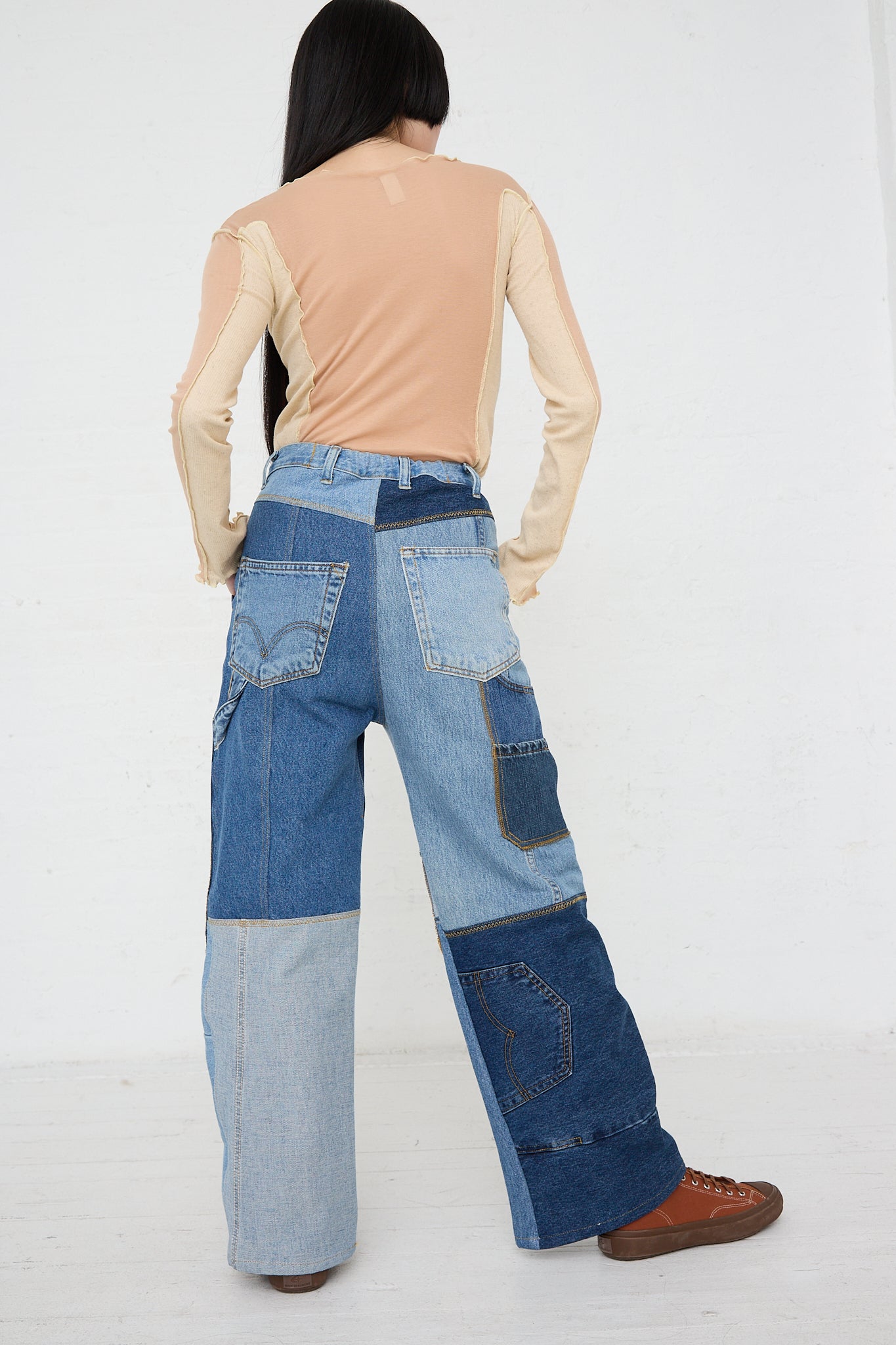 The back of a woman wearing a pair of WildRootz Reworked Jeans in Blue from a sustainable streetwear brand.