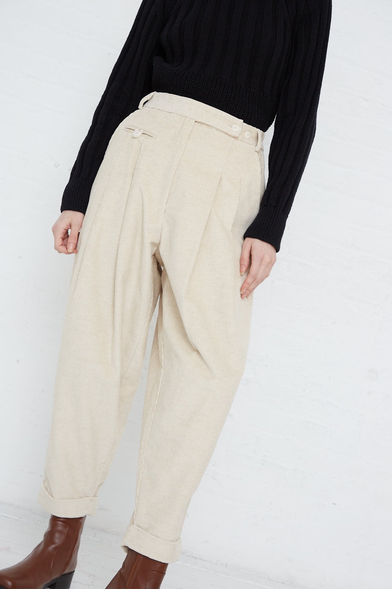 The model is wearing Corduroy Carrot Pants in Off White, made by Cordera.