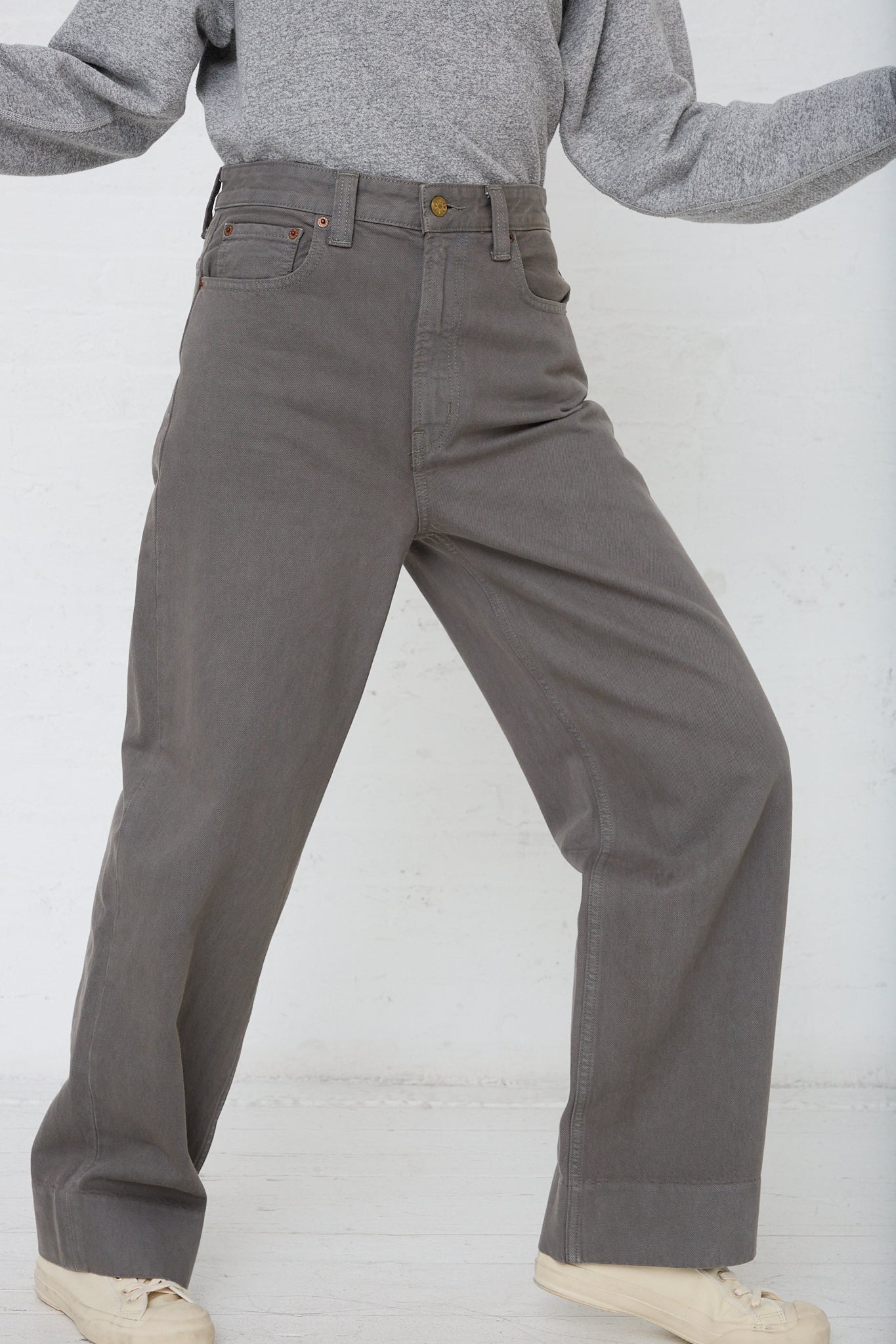 A woman wearing Easy Mid Relaxed Jean in Olive Overdye pants by B Sides.