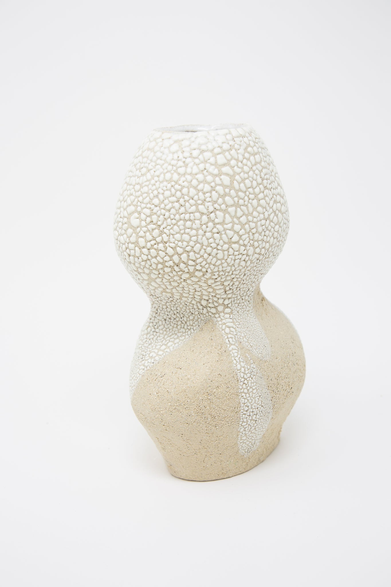 A Lost Quarry Hand Built Vessel No. 000744 Bud Vase crackle glazed vase resting on a white surface.