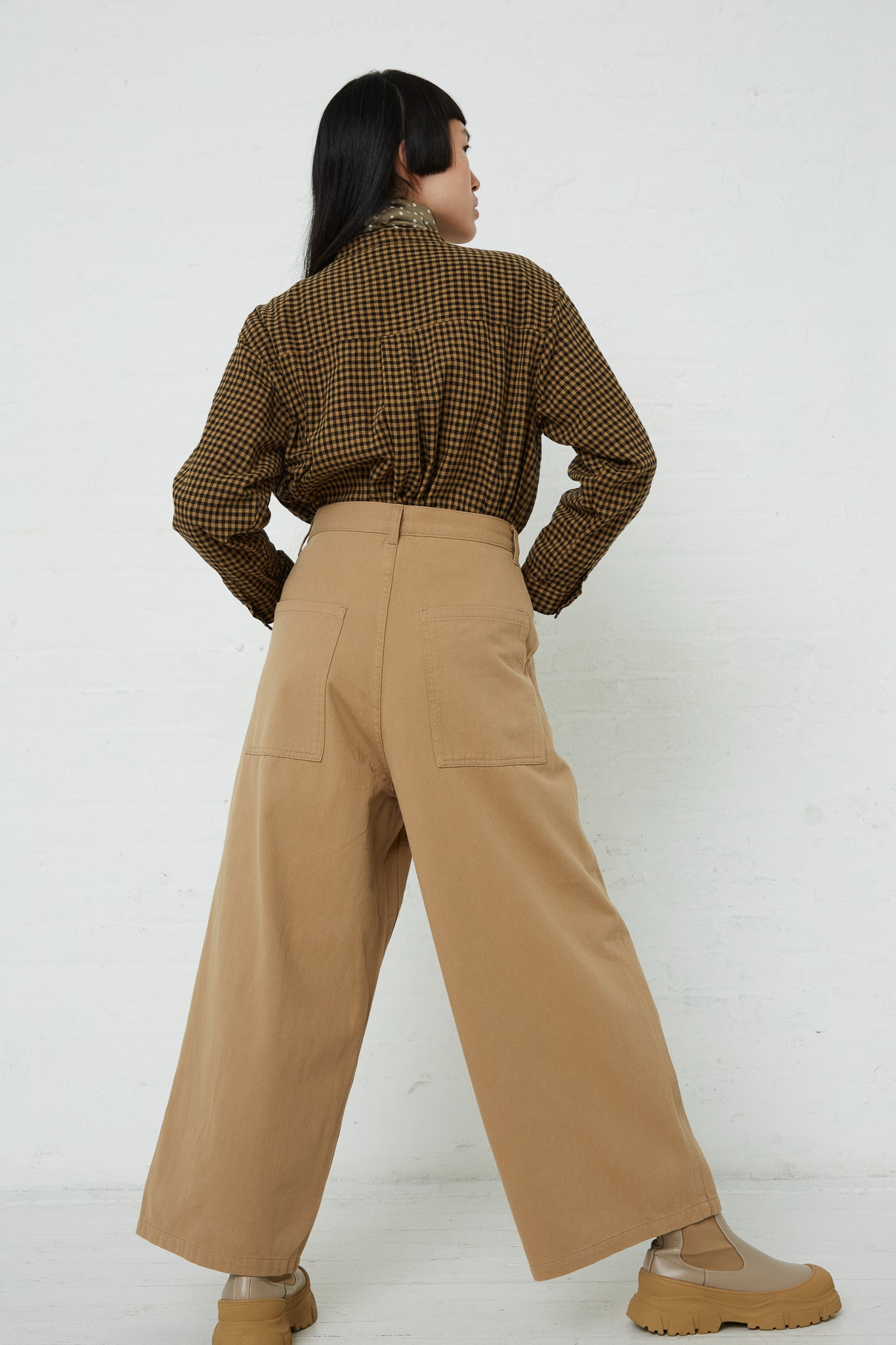 The back view of a woman wearing Ichi's Cotton Pant in Beige wide leg pants.
