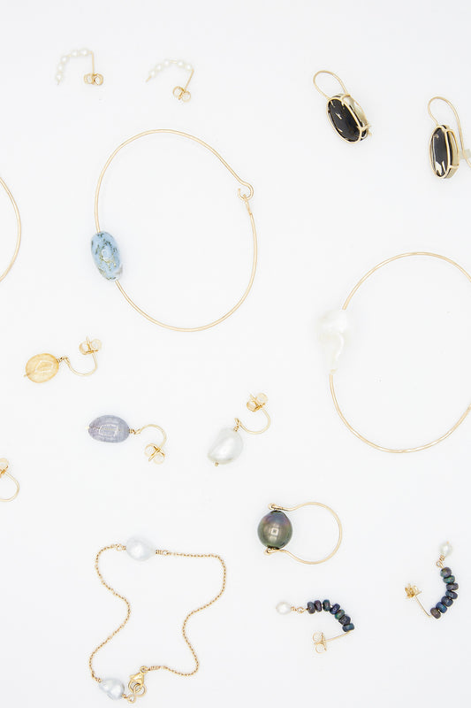 A collection of handmade 14K Chain Bracelets in Keshi Pearl by Mary MacGill.