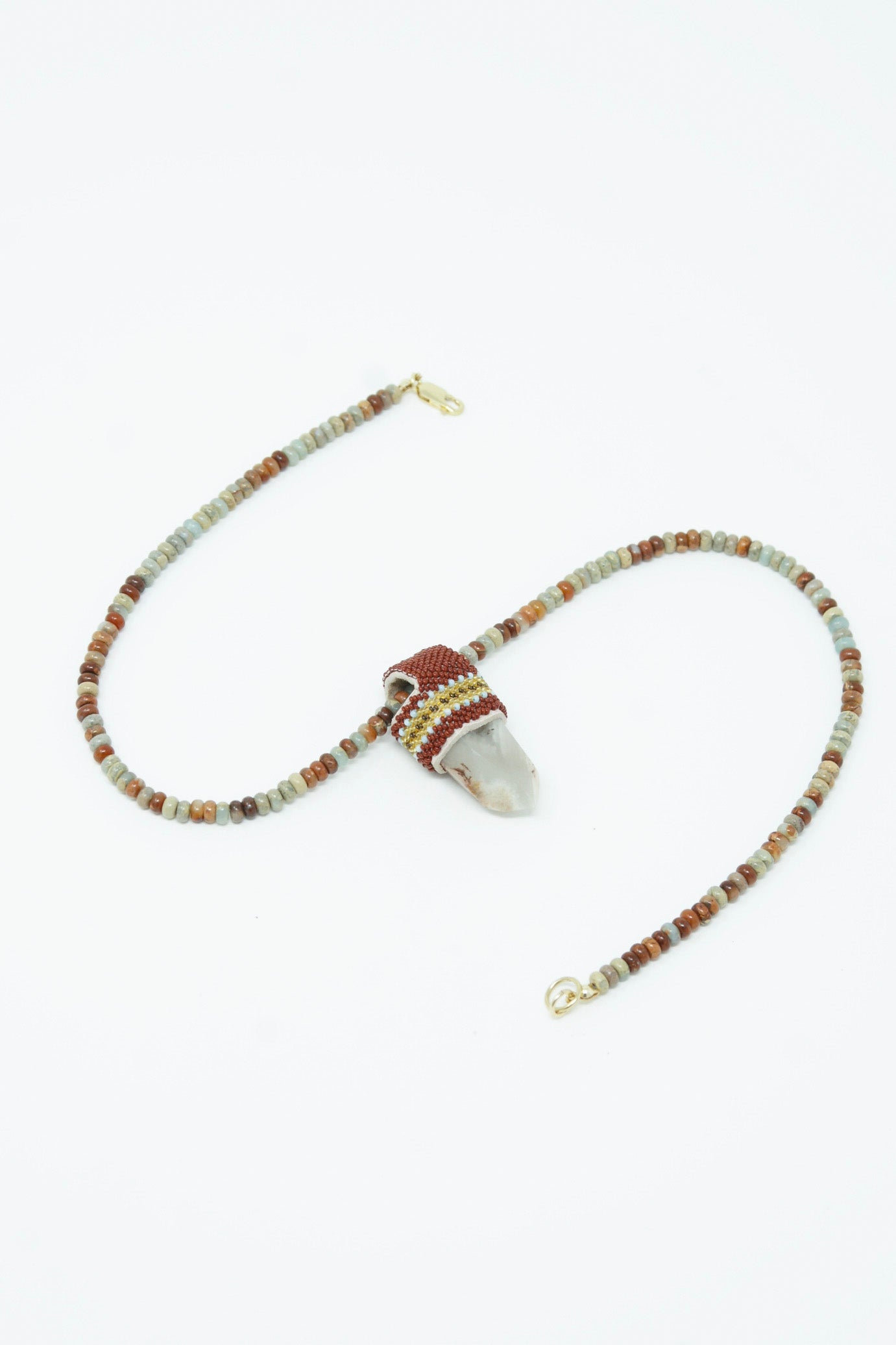 A Robin Mollicone pendulum necklace with Sea Sediment Jasper beads and Lithium Quartz.
