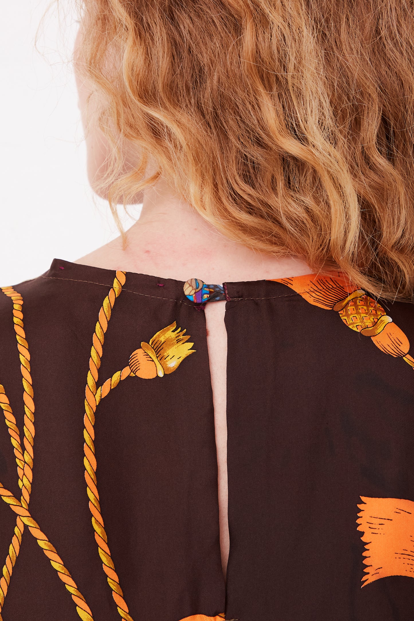 The back view of a woman wearing a Bettina Bakdal Silk Vintage Scarves Lena Hannah Dress - M.
