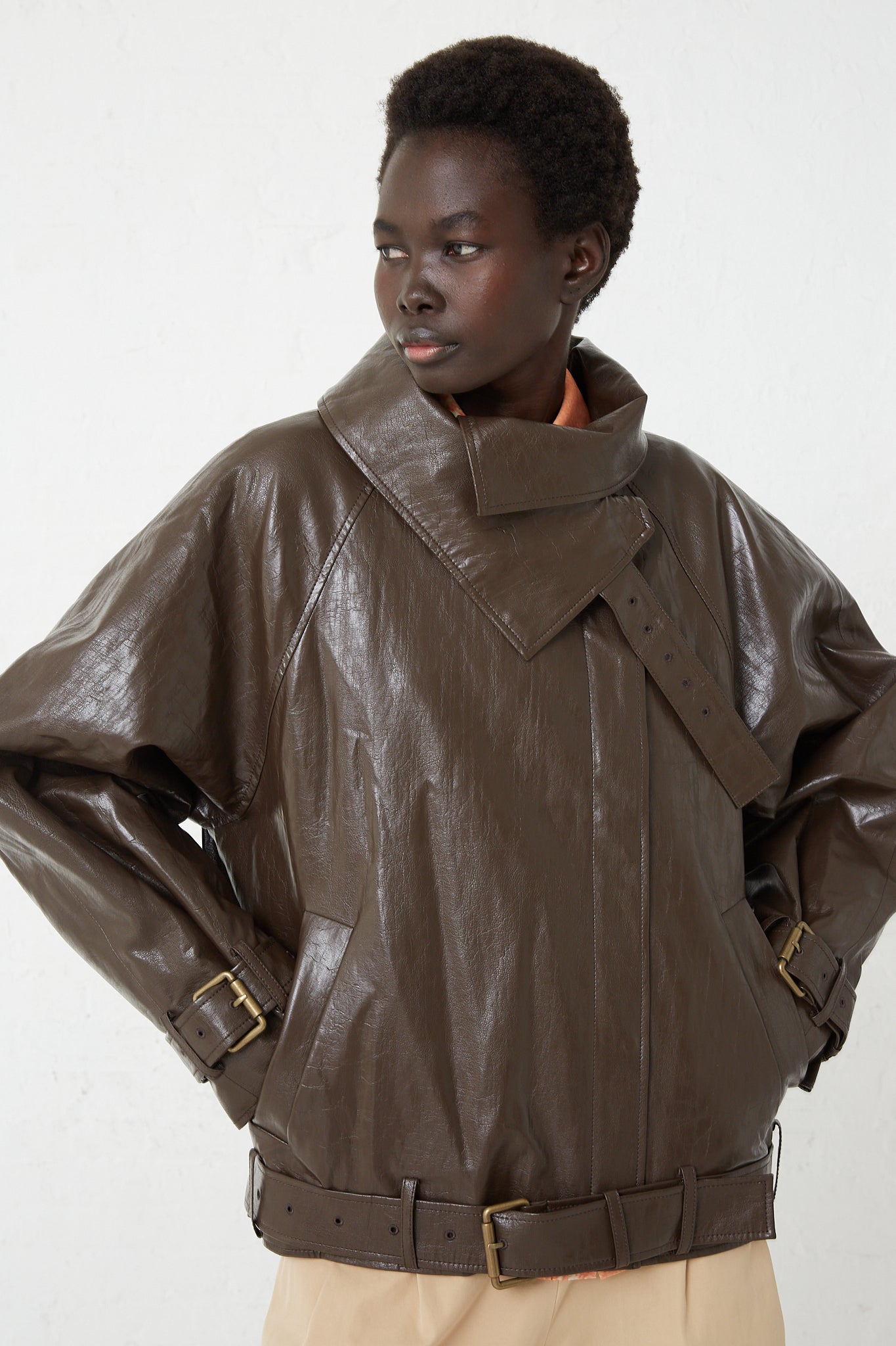 A model wearing a Faux Leather Juno Jacket in Dark Brown by Rejina Pyo.