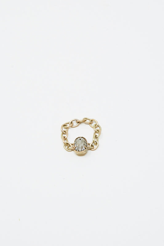 A unique La Mar 14K Gold Chain Link Ring 016 with a small stone on it.