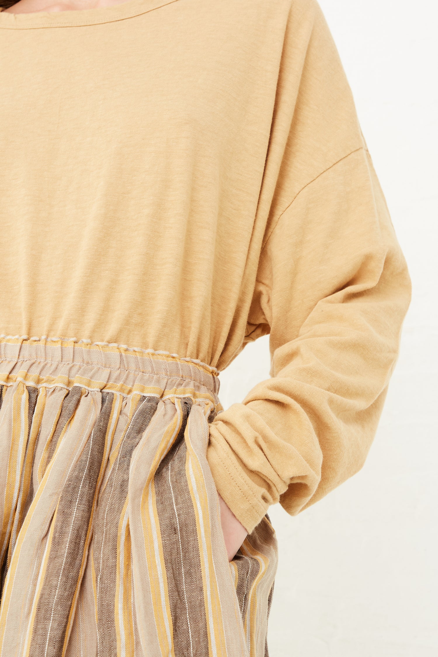 A model wearing an Ichi Antiquités Linen Stripe Skirt in Mustard, available at Oroboro store.