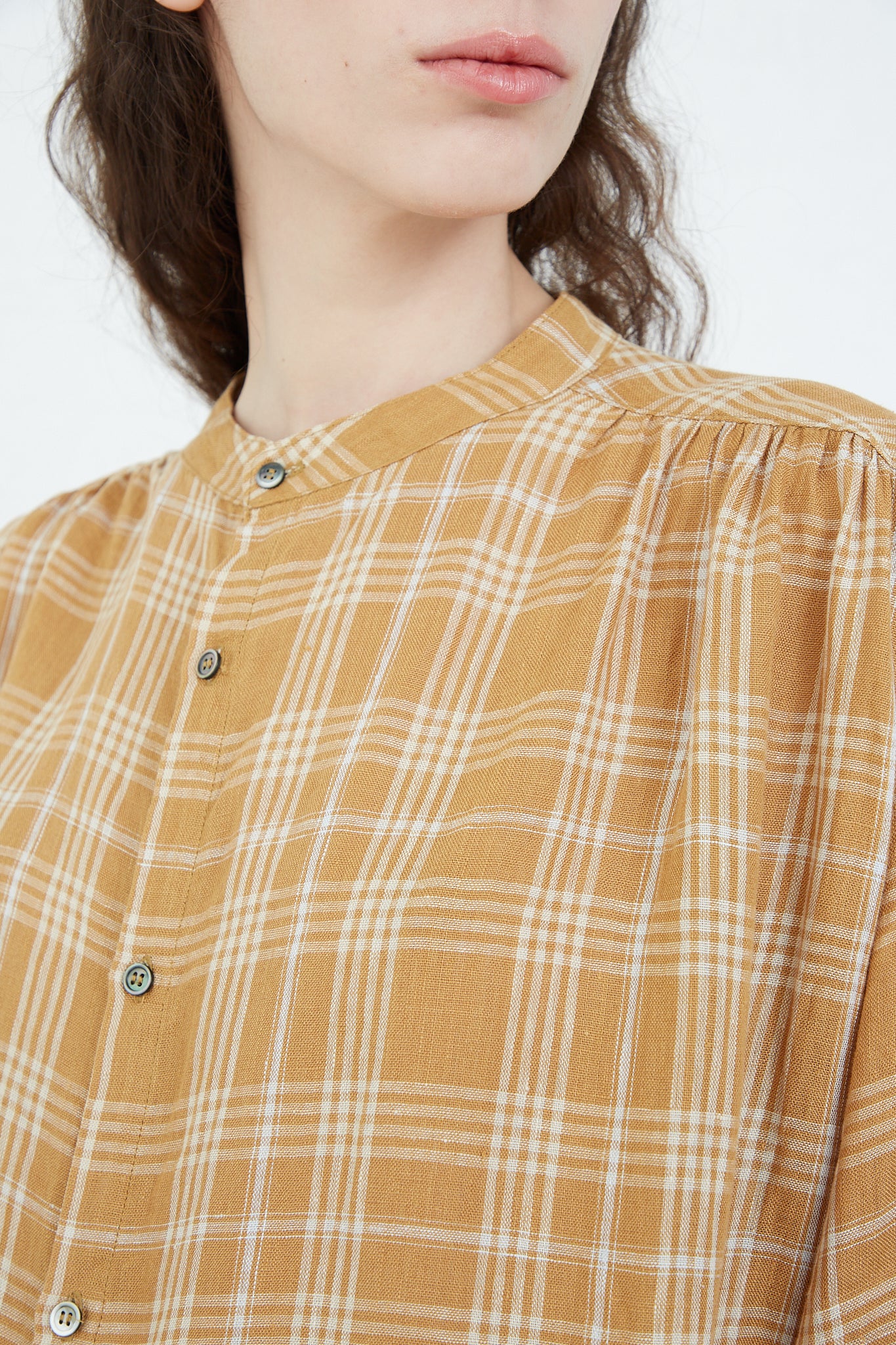 The model is wearing a Linen Check Dress in Camel by Ichi Antiquités.