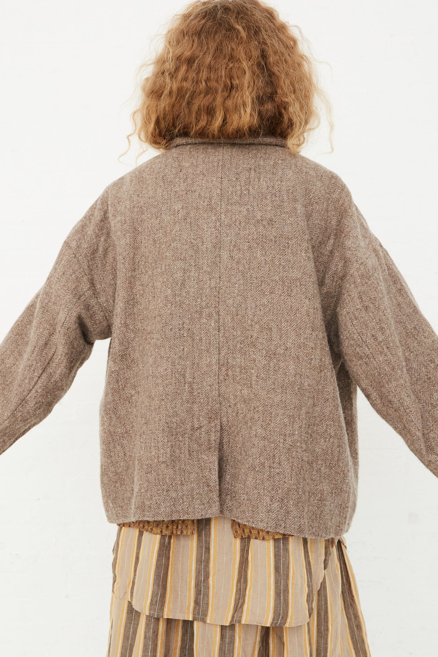 The back of a model wearing an oversized Ichi Antiquités Wool Herringbone Jacket in Mocha.
