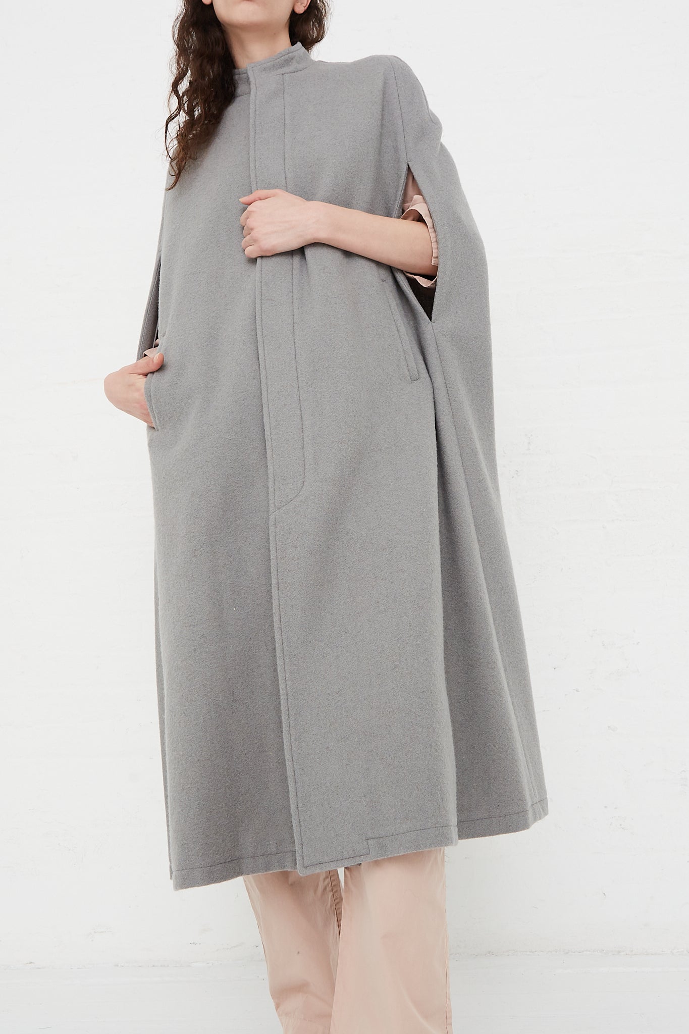 The model is wearing a Cosmic Wonder Japanese Suffolk Melton Cloak in Grey.
