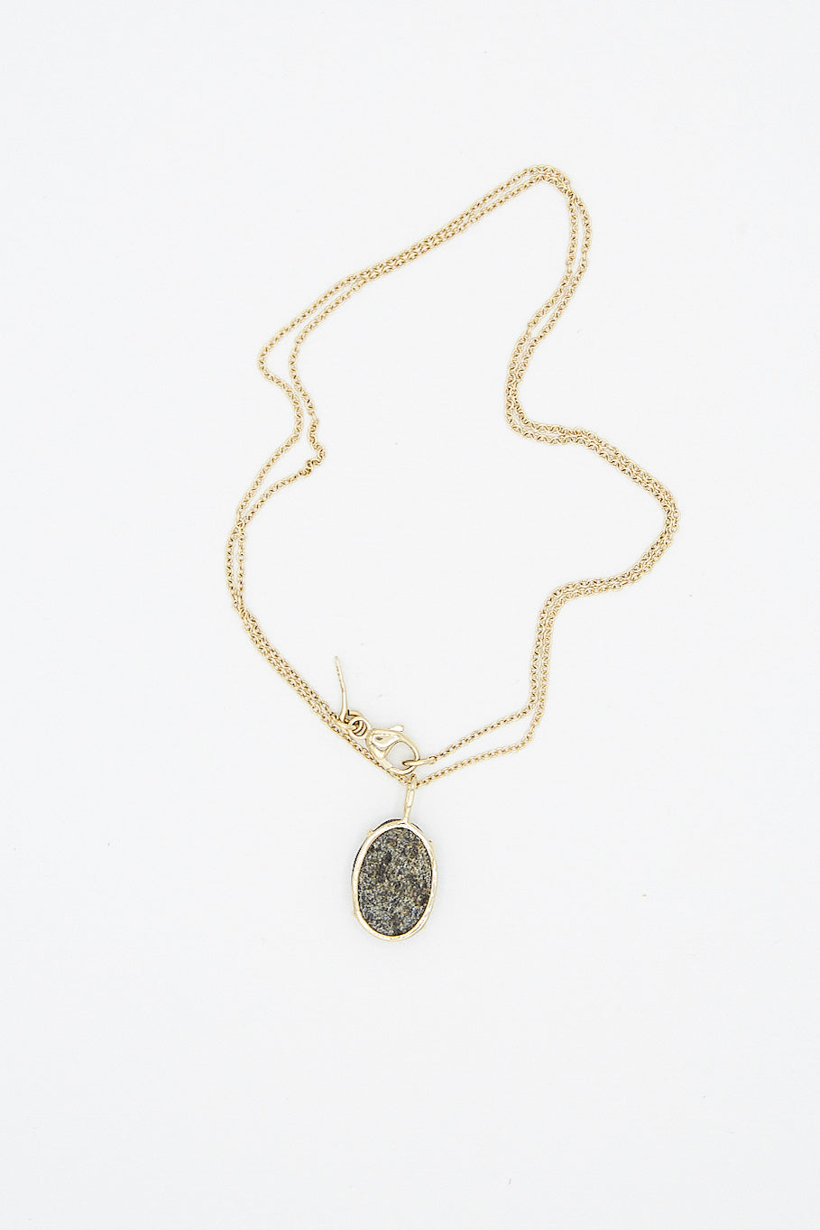 A Mary MacGill 14K Floating Necklace in Block Island Stone 16" Chain with a black stone also known as the Block Island Stone.