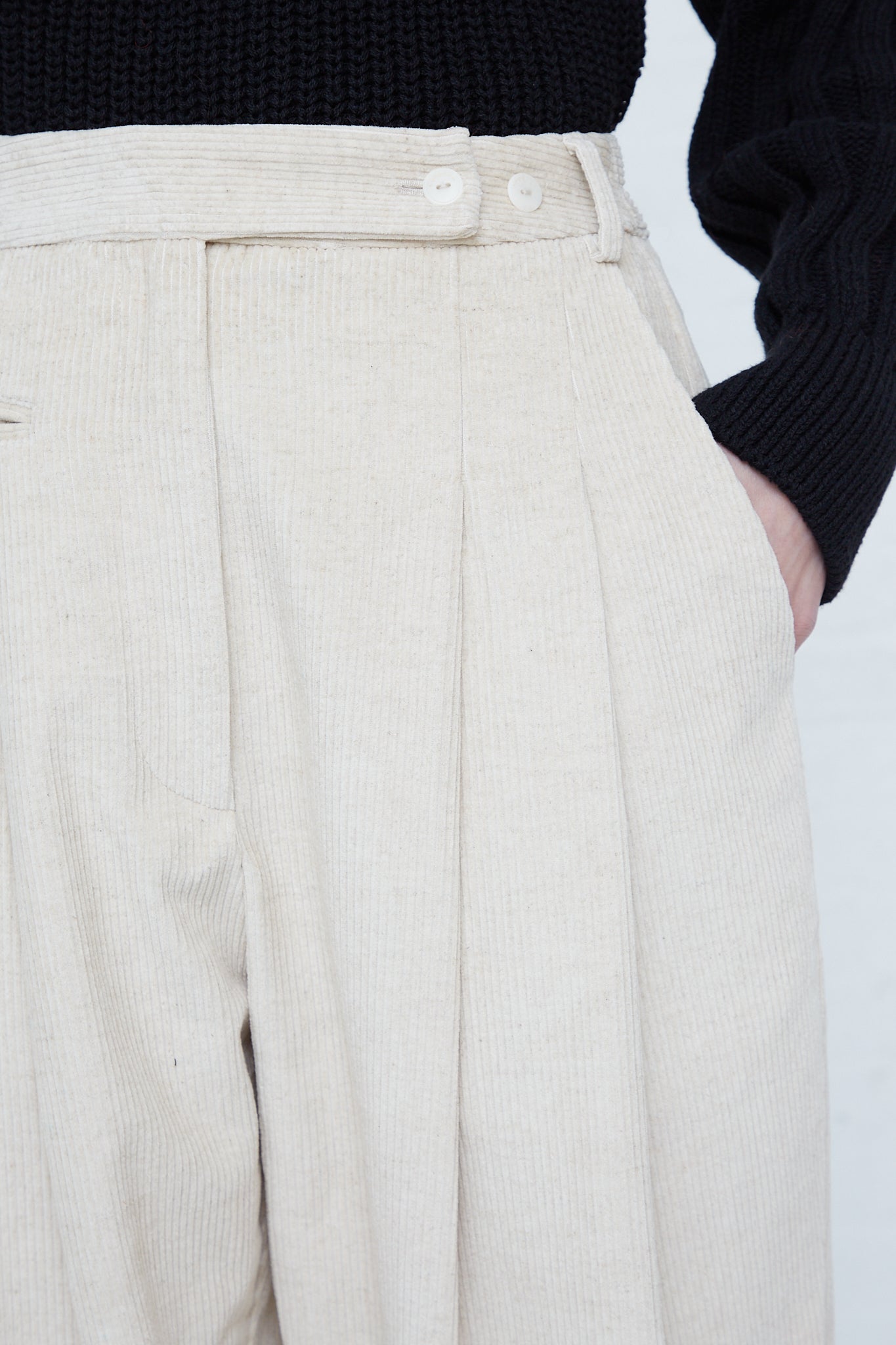 A woman wearing Cordera's Corduroy Carrot Pants in Off White made in Spain.