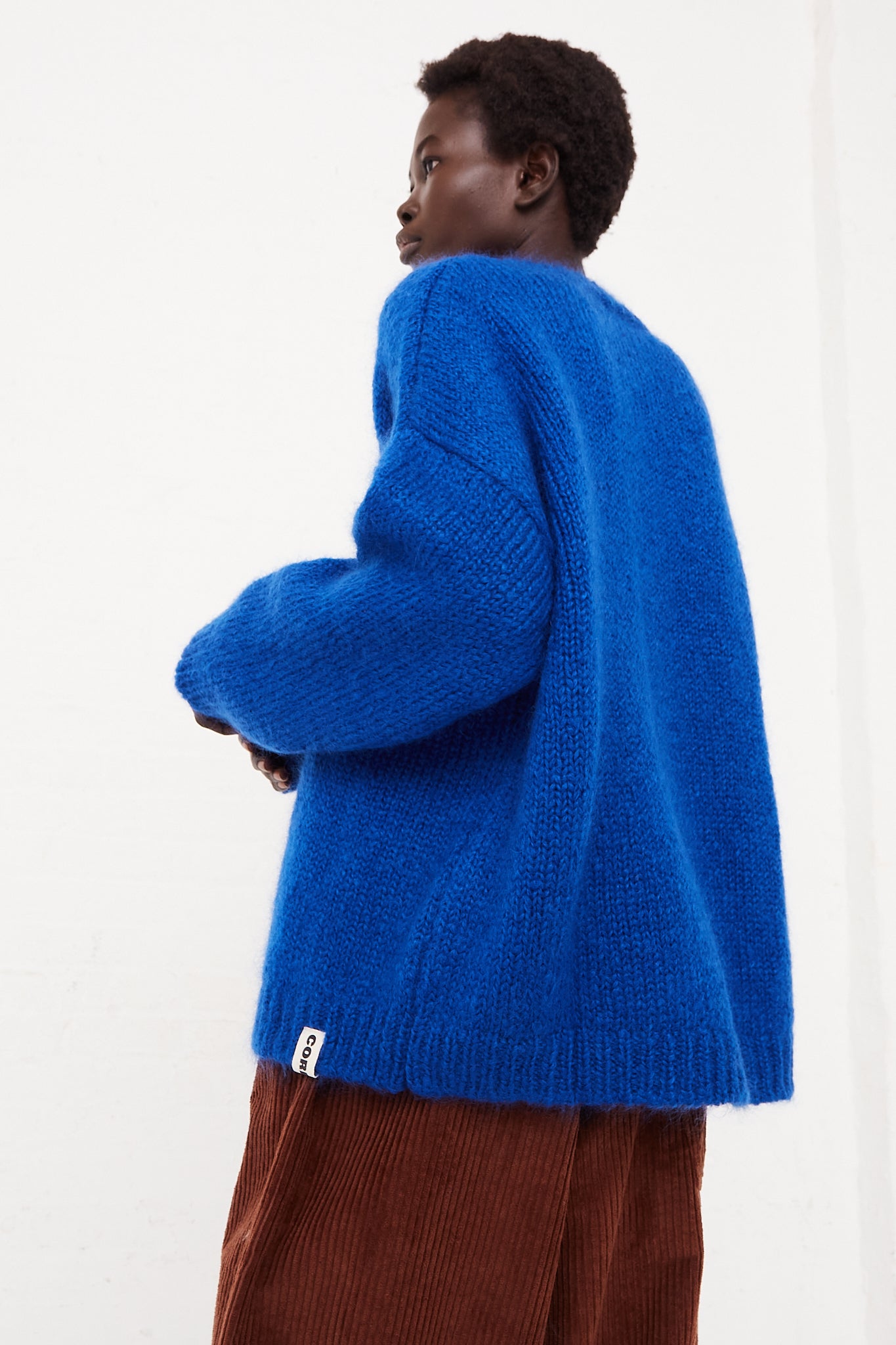 CORDERA Mohair Sweater in Blue | Oroboro Store | Side view of sweater upclose on model