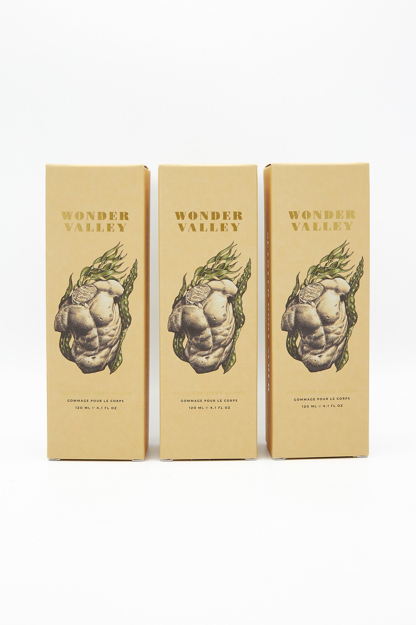 Three boxes featuring a woman showcasing the benefits of Wonder Valley Seaweed Body Scrub that exfoliates and detoxifies.
