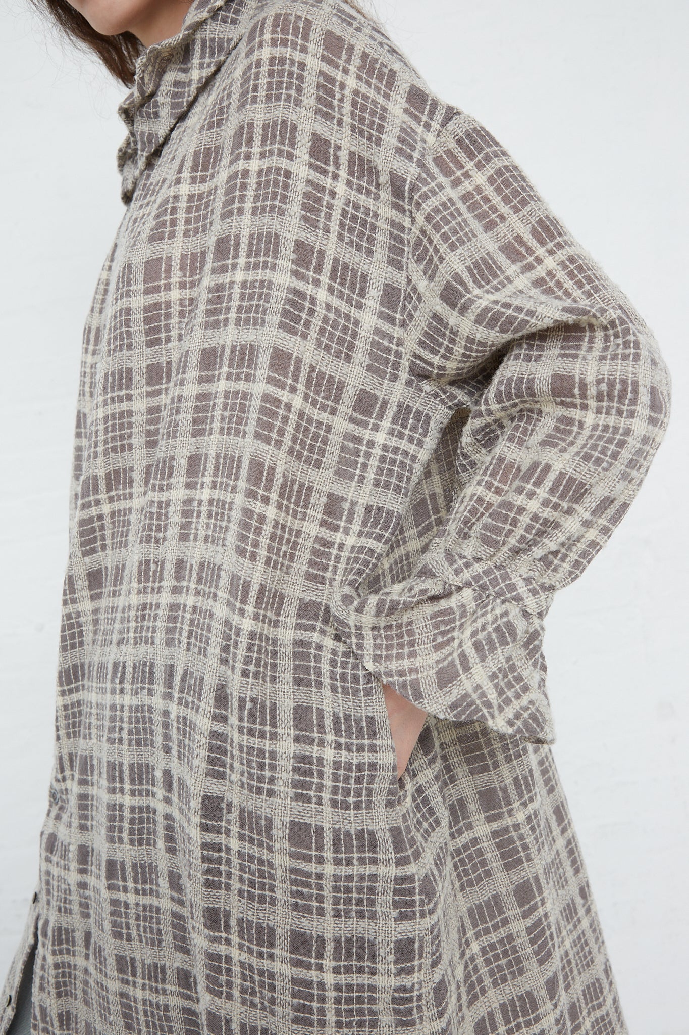 A woman wearing an Ichi Antiquités Wool Check Frill Dress in Mocha. Side view.