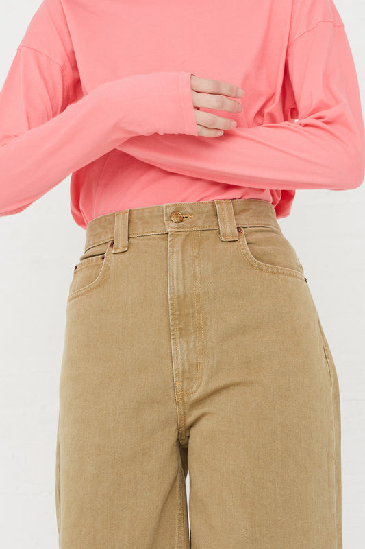 A model wearing a B Sides Cotton Easy Jean Mid Relaxed in Stone Rinse top and tan pants.