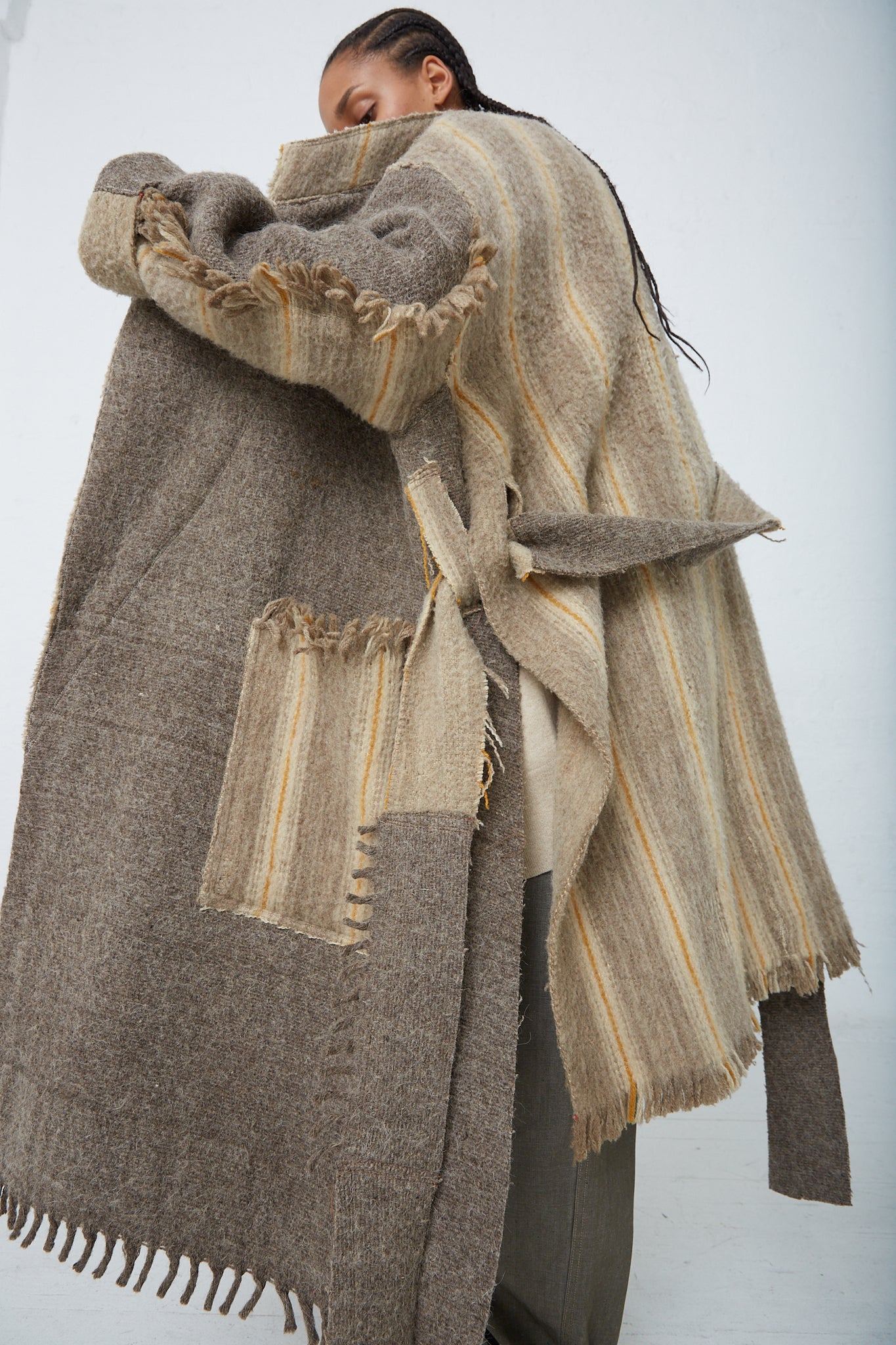 A woman wearing a Thank You Have A Good Day Wool Blanket Swing Trench. Coat open.