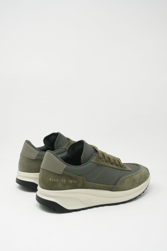 A pair of olive Track Technical Article sneakers from Common Projects with suede overlays and a foam midsole on a white background.