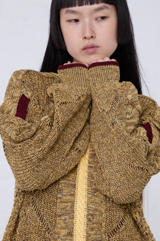 A young woman wearing a TOGA PULLA Mesh Knit Pullover in Yellow.